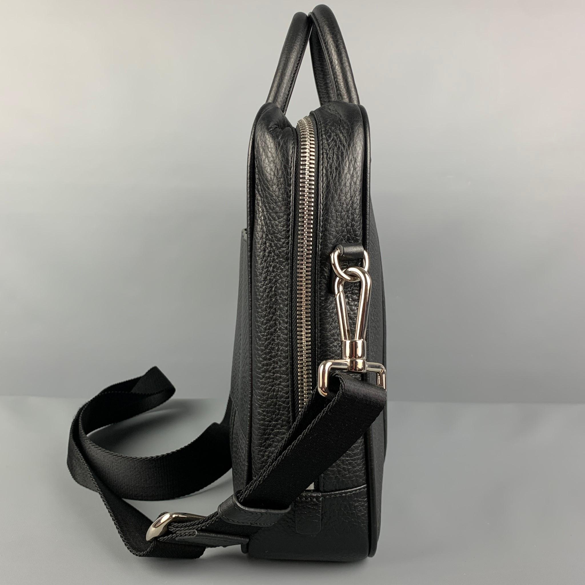 BALLY bag comes in a black textured featuring a briefcase design, detachable shoulder strap, silver tone hardware, back pocket, and a zipper closure. Comes with tags.

Very Good Pre-Owned Condition.

Measurements:

Length: 14 in.
Width: 3