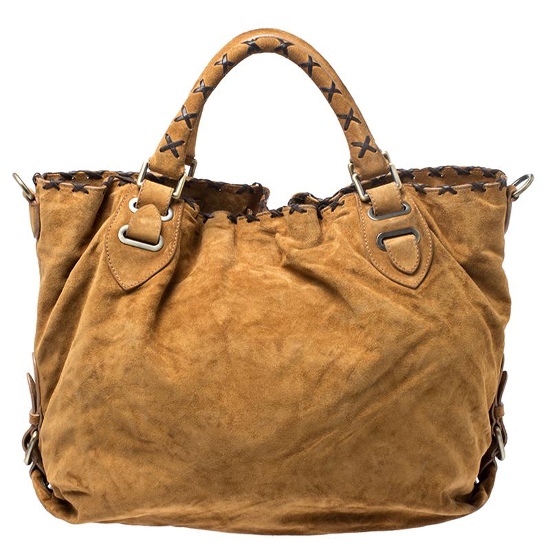 Elevating your look with a simple design is this tote from Bally. This bag in brown has been meticulously crafted from suede as well as leather and equipped with a spacious nylon interior that can easily hold all your essentials. Held up by two