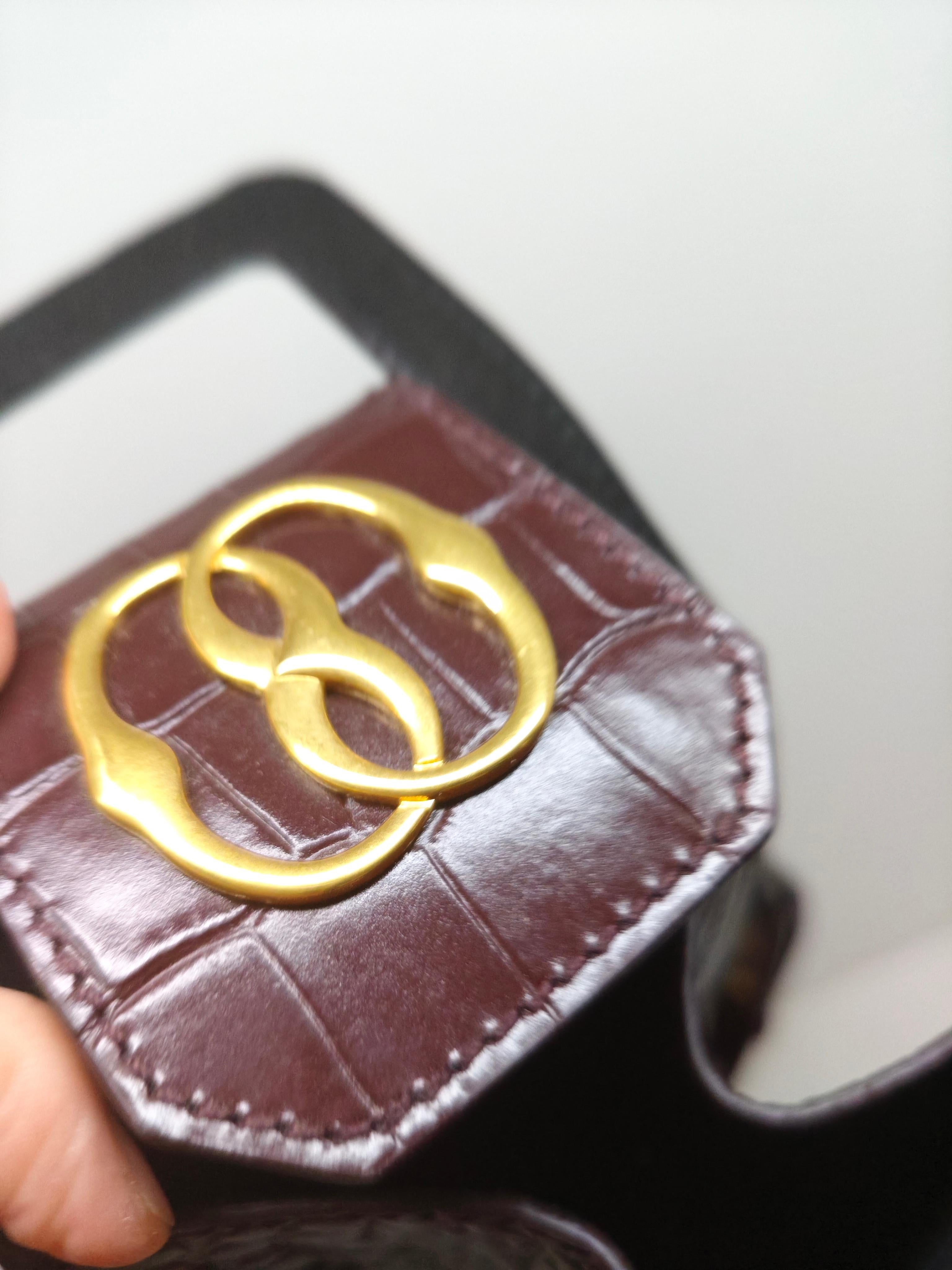 Add a touch of sophistication to your accessories collection with this Bally Croc-Embossed Wine Bag, a statement piece that seamlessly blends luxury and functionality. Crafted from premium leather with an elegant crocodile-embossed texture, this bag