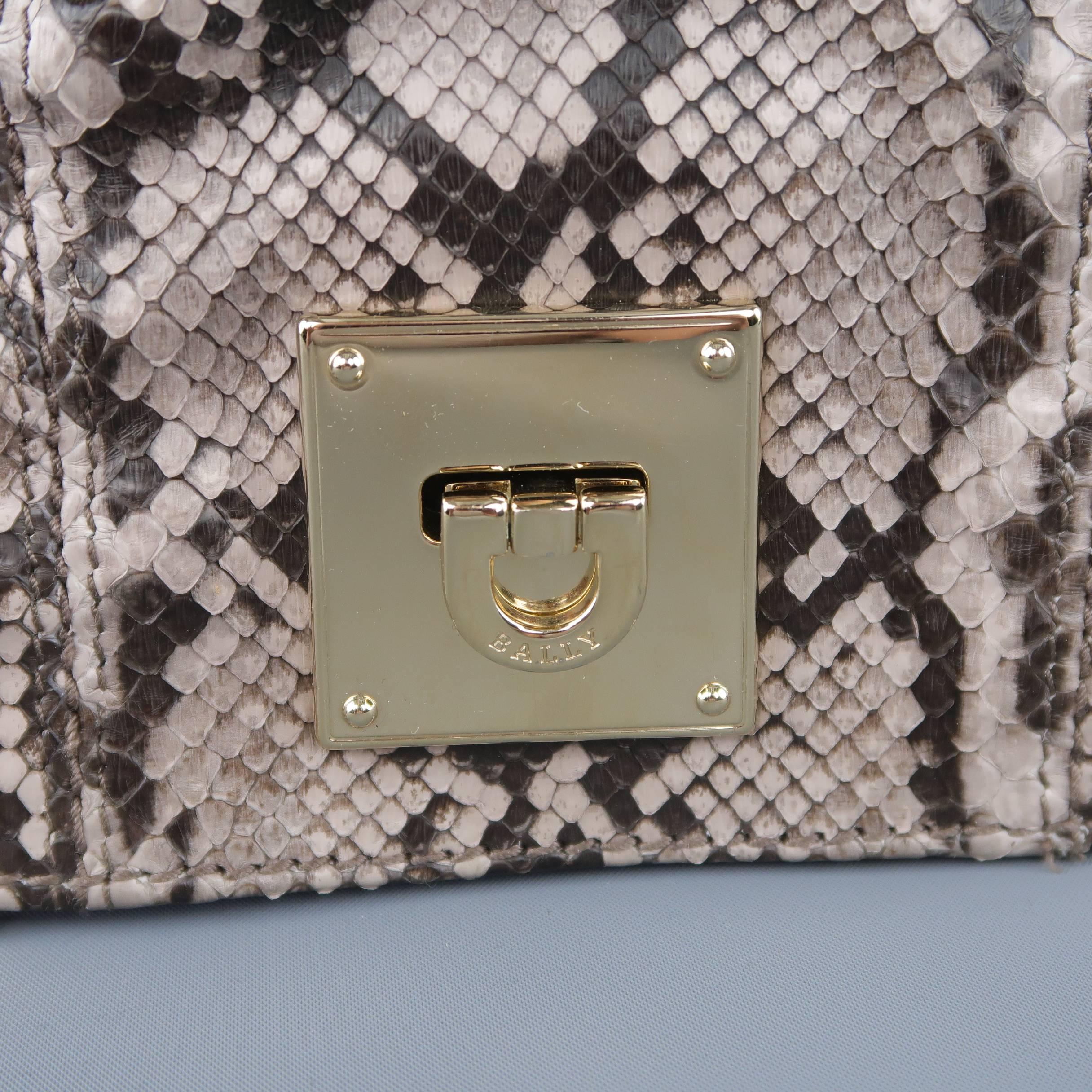 BALLY clutch bag comes in purple tone gray python skin leather with a ruched front, light gold tone hardware, and multi section accordion construction. Made in Italy.
 
Excellent Pre-Owned Condition.
 
Measurements:
 
Length: 10 in.
Width: 2