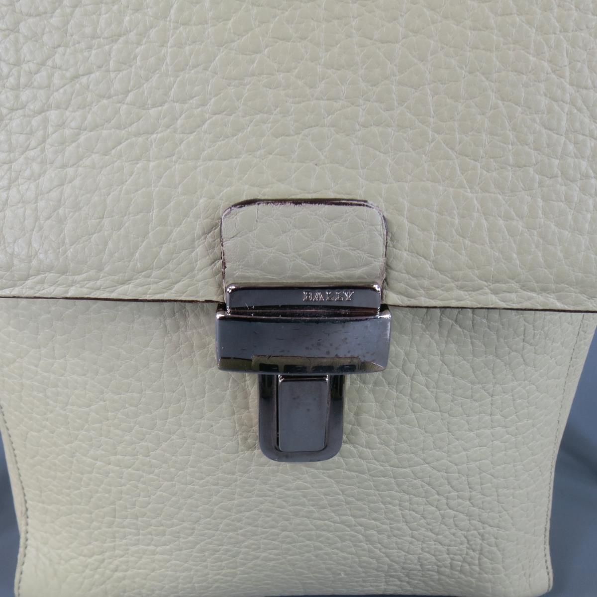 Vintage BALLY bag in a unique mint greenish tone beige textured leather featuring a flap with silver tone buckle, double storage compartments, and shoulder strap with rubber grip panel. In excellent condition with exception of the buckle being