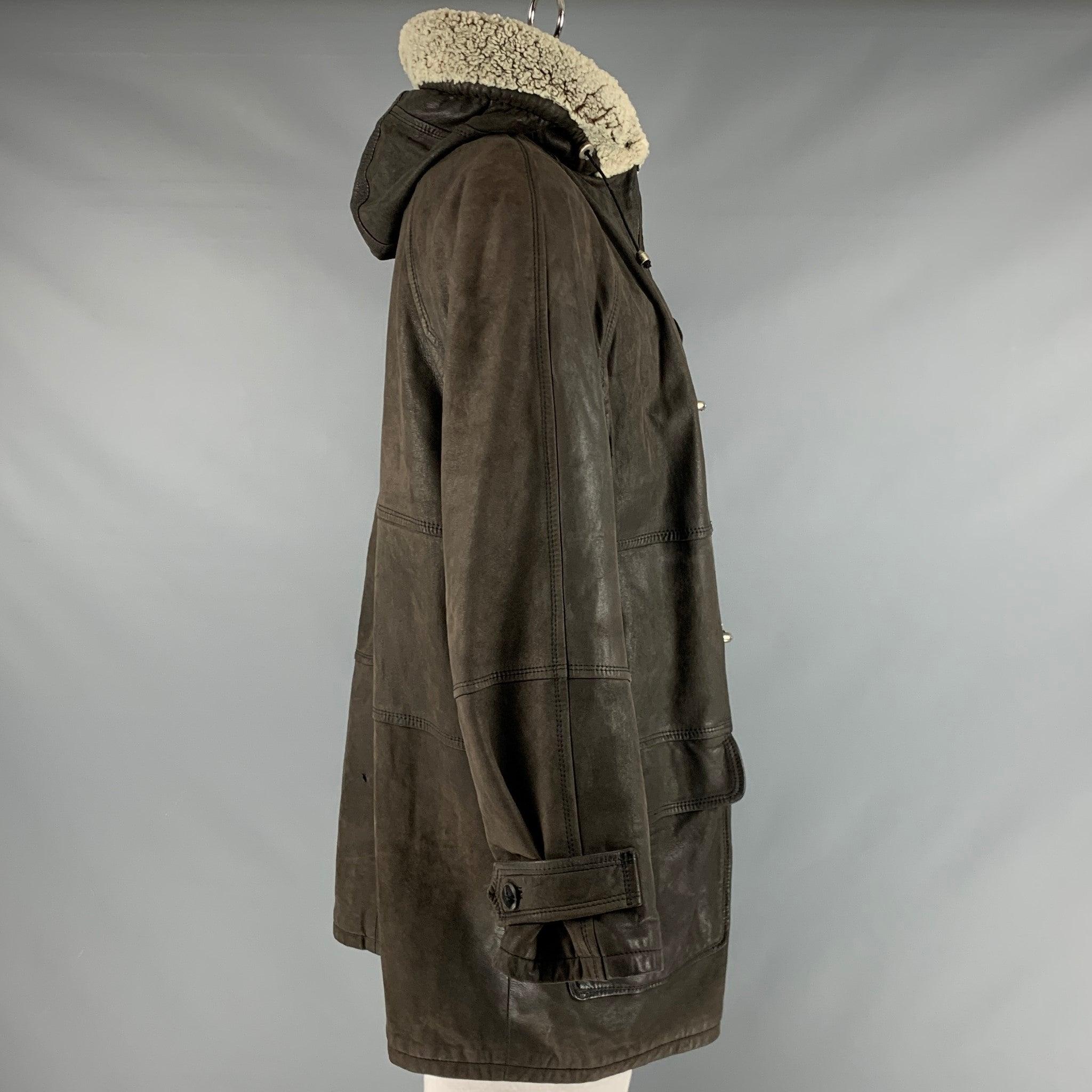 BALLY coat
in a grey olive green leather fabric featuring a nautical style, removable hood with shearling trim, and zip and fishermen's toggle button closure. Made in Italy.Very Good Pre-Owned Condition. Moderate signs of wear. 

Marked:   48
