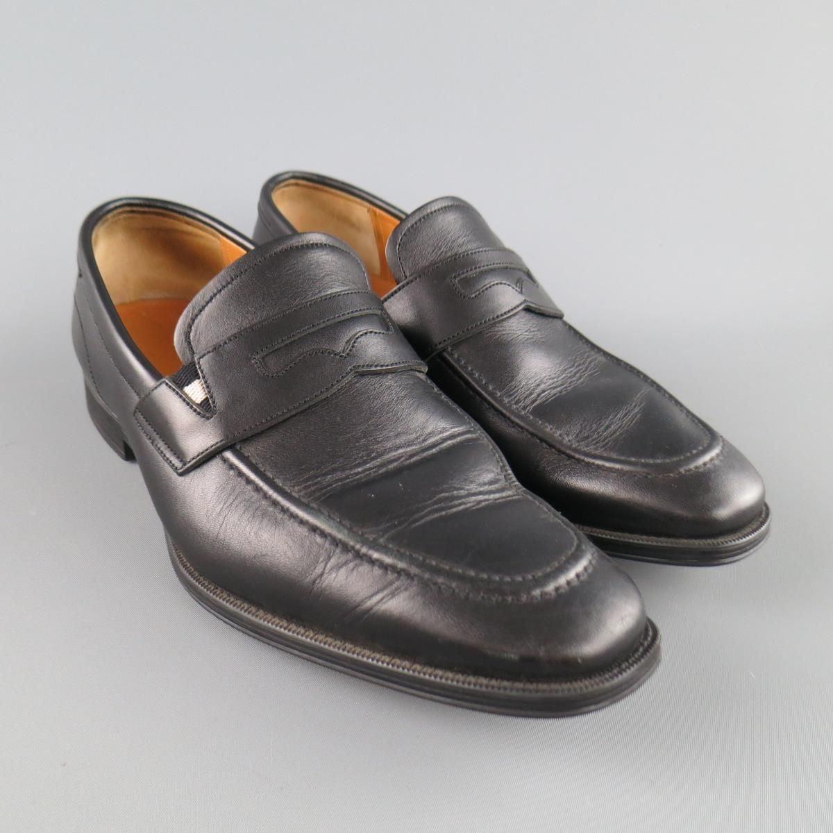 BALLY penny loafers come in black smooth leather and feature an apron tow and penny strap with striped elastic detail. with Box. Made in Switzerland. Excellent Pre-Owned Condition. 

Marked:   7.5Outsole: 11.5 x 4 inches 
  
  
 
Reference: