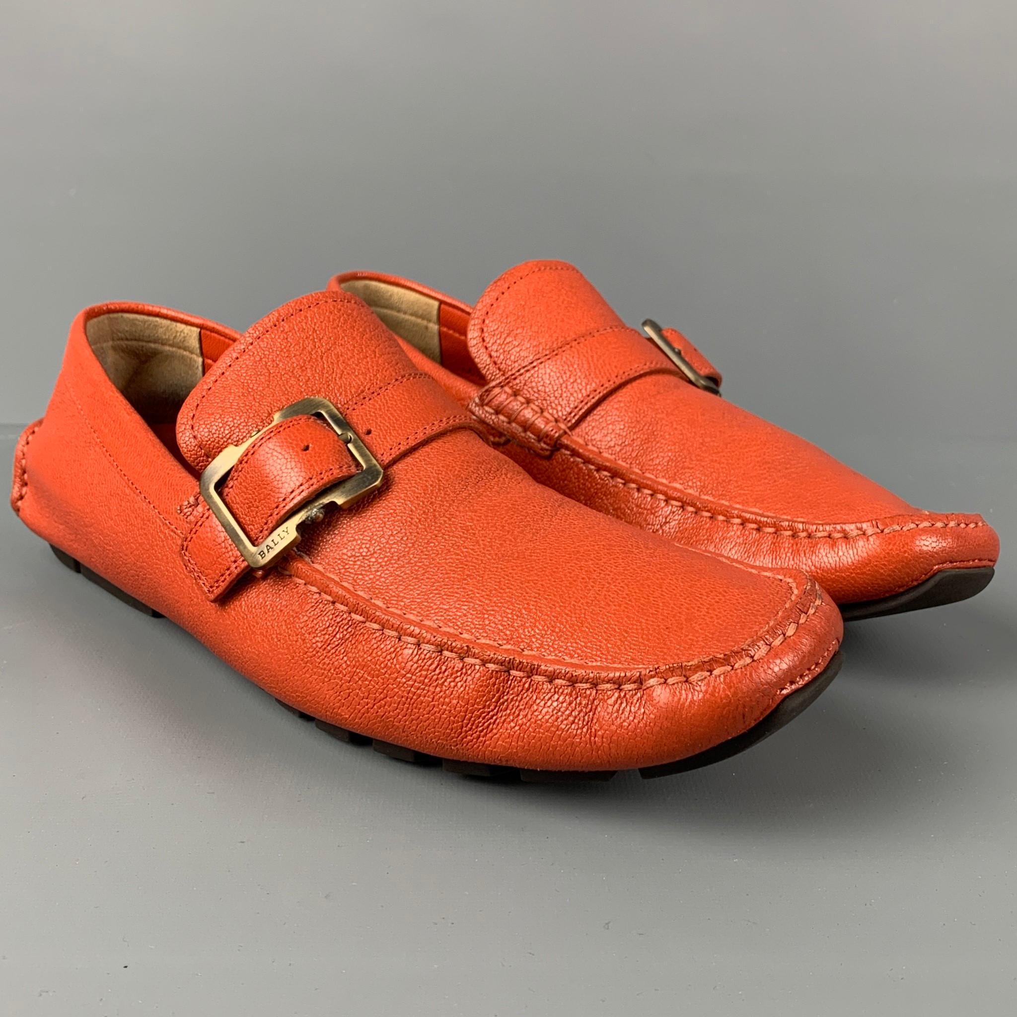 BALLY loafers comes in a orange leather featuring a drivers style, square toe, and a buckle strap detail. 

Very Good Pre-Owned Condition.
Marked: EU 6.5 E / US 7.5 D

Outsole: 11.5 in. x 4 in. 
