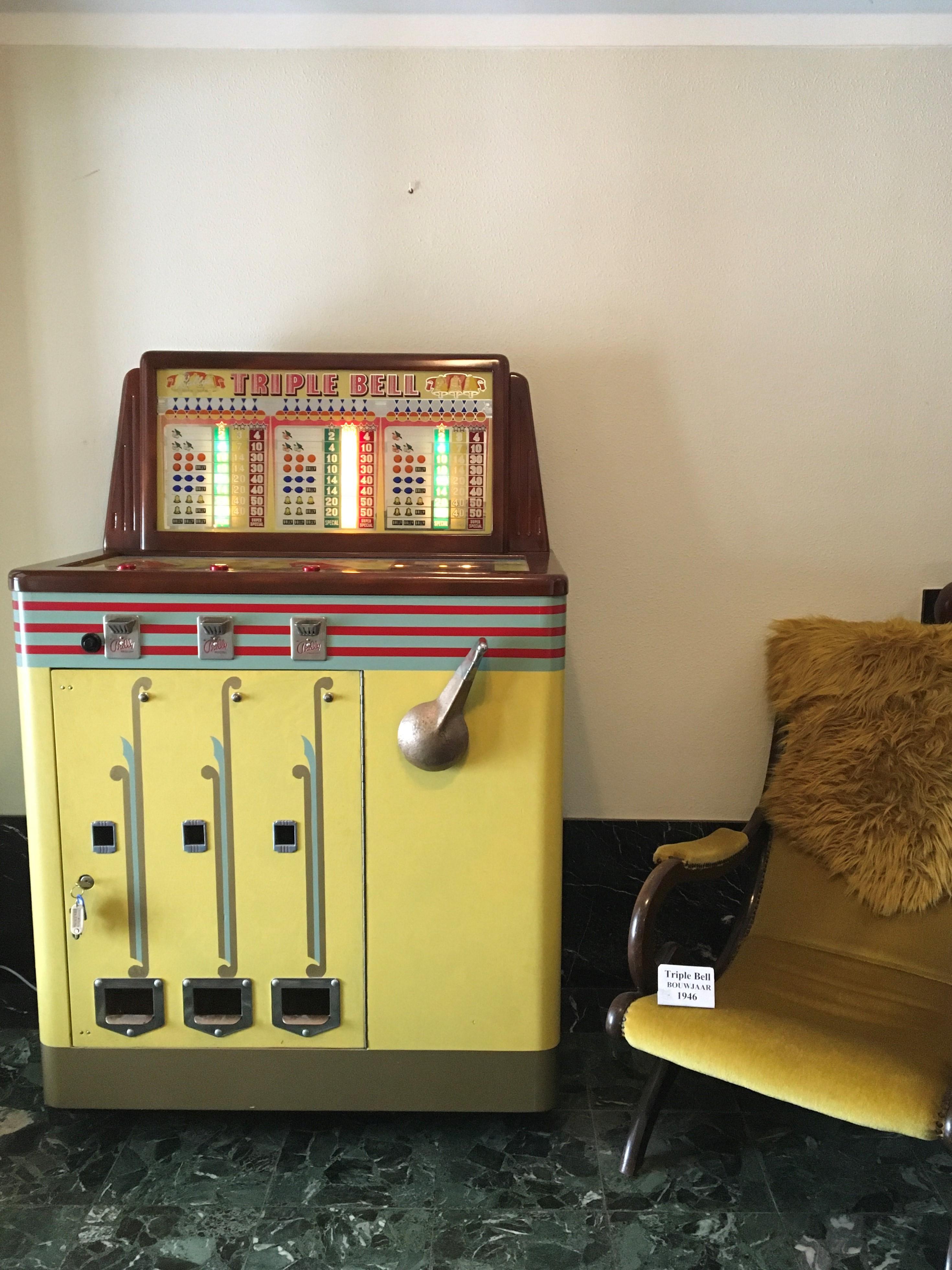 1946 Bally Manufacturing Co. - Triple bell - Console slot machine - one-armed Bandit.

This Art Deco vending machine that we sell was restorated as well on the inside as outside. 
The outside looks great by his design and colors and with the