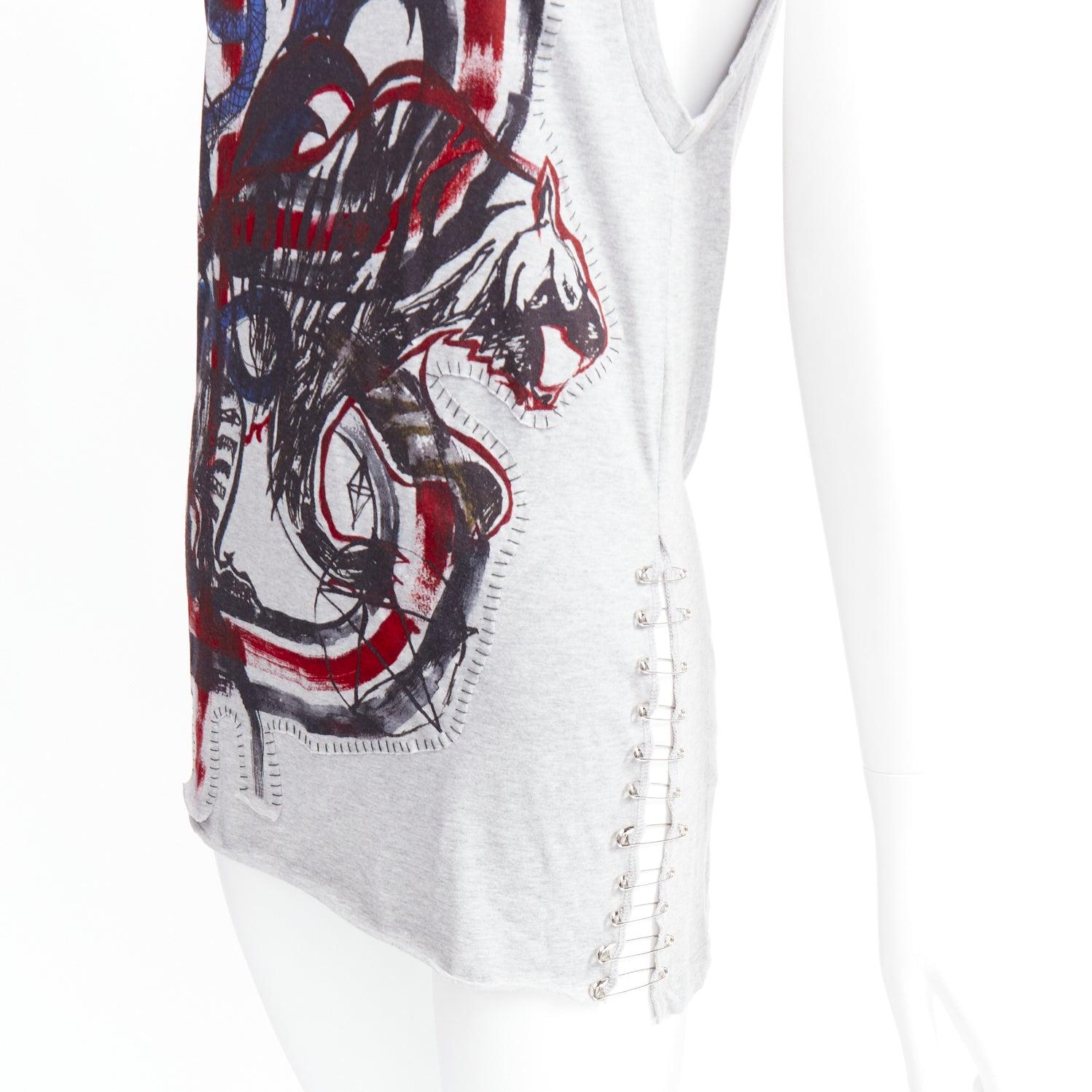 BALMAIN 2011  Christophe Decarnin Punk Graffiti silver pin ripped tank top FR38 M
Reference: NKLL/A00503
Brand: Balmain
Designer: Christophe Decarnin
Collection: SS 2011
Material: Cotton
Color: Grey, Red
Pattern: Photographic Print
Closure: