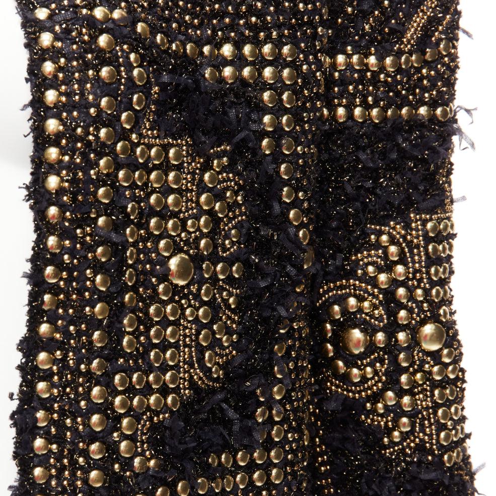 BALMAIN  2022gold black boucle tweed gold studded power shoulder jacket FR34 XS
Reference: AAWC/A01080
Brand: Balmain
Designer: Olivier Rousteing
Collection: Resort 2022
Material: Polyamide
Color: Black, Gold
Pattern: Studded
Closure: Hook &