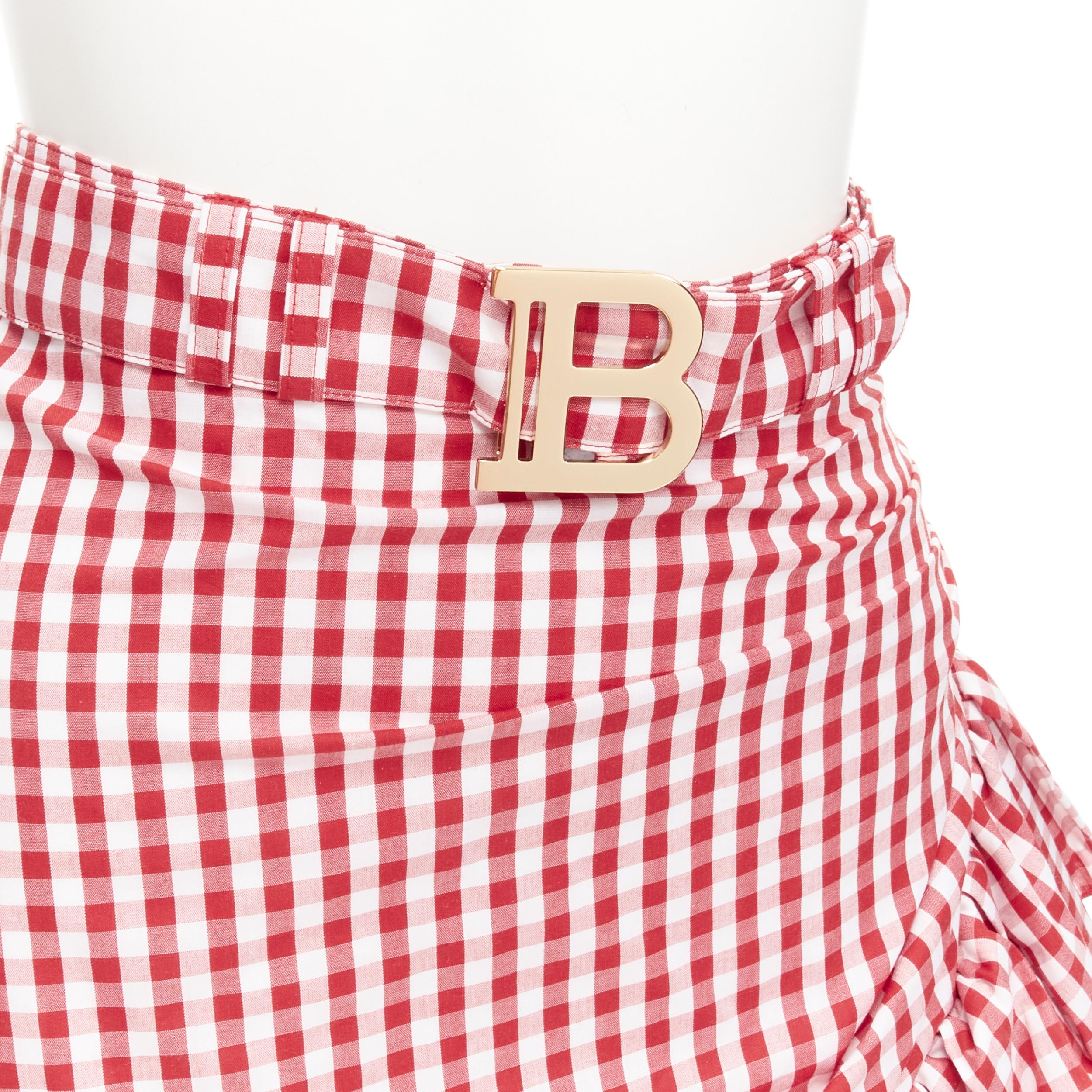 BALMAIN B logo buckle red white gingham ruffled cottage skirt FR34 XS
Reference: AAWC/A00360
Brand: Balmain
Designer: Olivier Rousteing
Material: Cotton
Color: Red, White
Pattern: Plaid
Closure: Zip
Lining:  Fabric
Extra Details: Gold tone logo zip