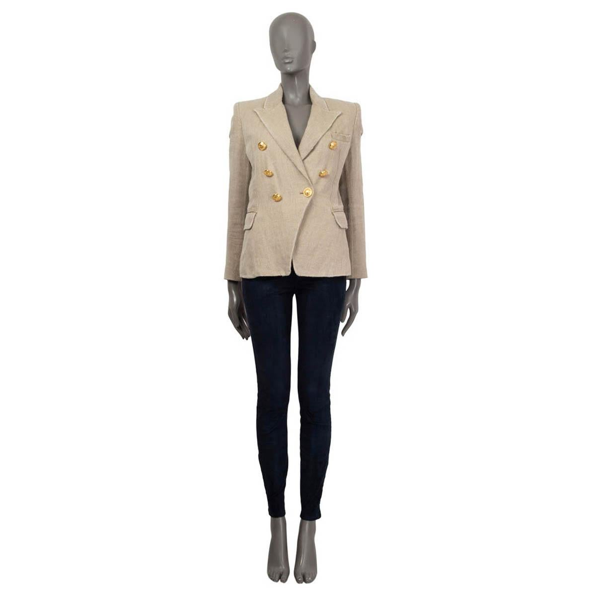 100% authentic Balmain double-breasted blazer in beige linen (100%). Features a chest pocket and two flap pockets on the sides. With padded shoulders and buttoned cuffs. Closes with signature lion-head buttons in gold-tone metal. Lined in black