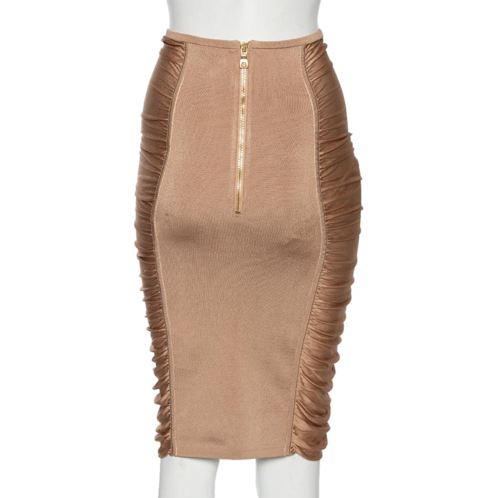 Exemplary in appearance and tailored perfectly, this skirt from Balmain will add a defining edge to your look. It has been stitched using beige stretch knit fabric and showcases a lace-up feature, ruched detailing, and a pencil fit. It comes with a