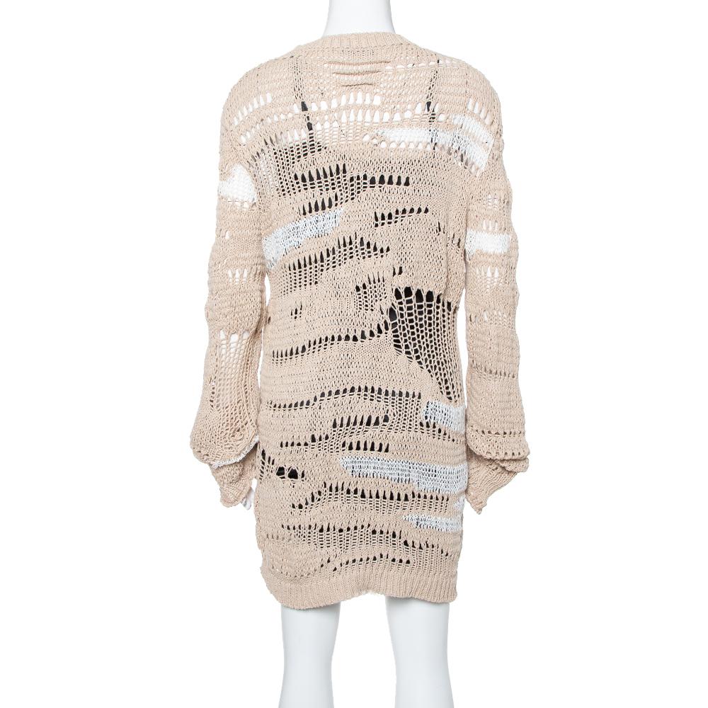 Exhibiting a distressed style in a soft beige hue, Balmain's knit creation can be worn over a short slip dress or with a camisole and leggings. It is soft, well-made, and comfortable to wear.


