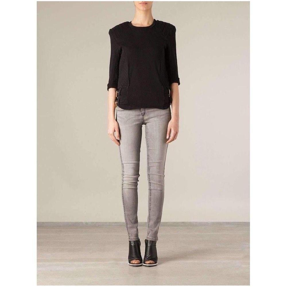 Black blouse with quilted details at sides and gold buckles  Relaxed-fit top in black. Crewneck collar. Tonal stitching.  Body: 100% cotton.