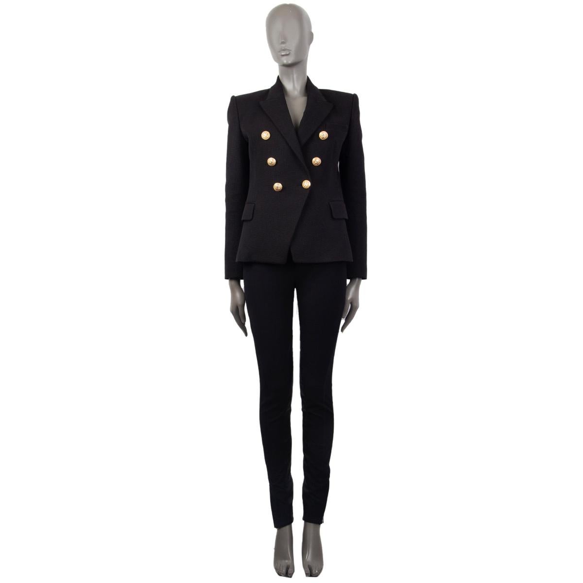 Balmain signature double-breasted blazer in black cotton (100%) with a braided fabric, slim-fitting silhouette, one patch pocket on the chest, two flap pockets and buttoned cuffs at the back. Closes with embosses logo gold-tone buttons in the front.