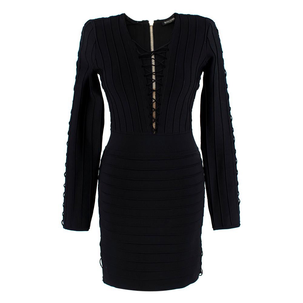 Balmain Black Fitted Lace-Up Mini Dress

- Padded shoulders for structure
- Gold hardware on the zip going down the back bodice
- Large ribbed design on the sleeves and down the breast
- Above the knee length
- Cross detailed rope in black
- Thick