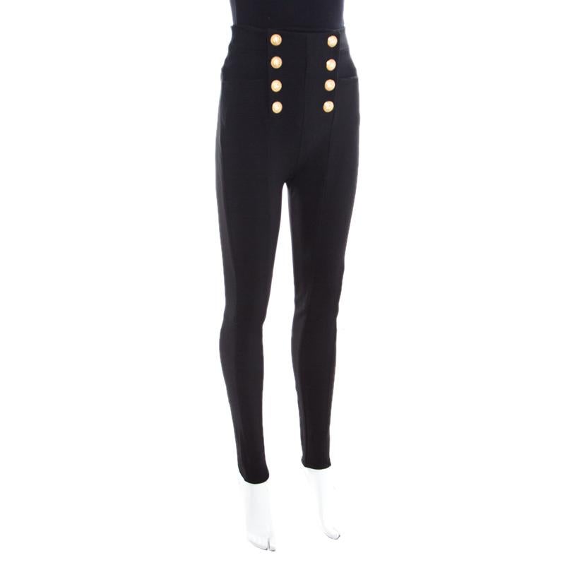 Your chic wardrobe deserves everything contemporary and edgy and what better than these black trousers from Balmain! These trousers are made of a viscose blend and feature a high waisted silhouette. They flaunt a logo button detailing on the front