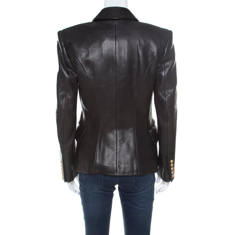 A blazer as finely tailored as this one from Balmain deserves to be in your closet. It has been made from leather and it flaunts a black shade, double-breasted style, and pockets. It'll look perfect with dresses and statement booties.

Includes: The