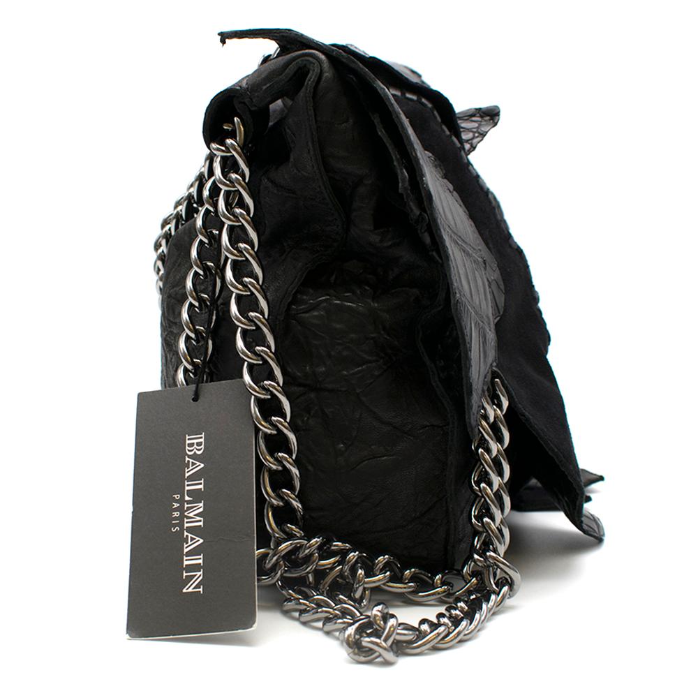 Balmain Crocodile Black Patchwork Bag	

Detailed stitching on exterior of bag.
Chain detailed
embellishments on front of bag.
Suede and leather patchwork.
Heavy chain strap with leather strap detail.
Large compartment with separate side zip