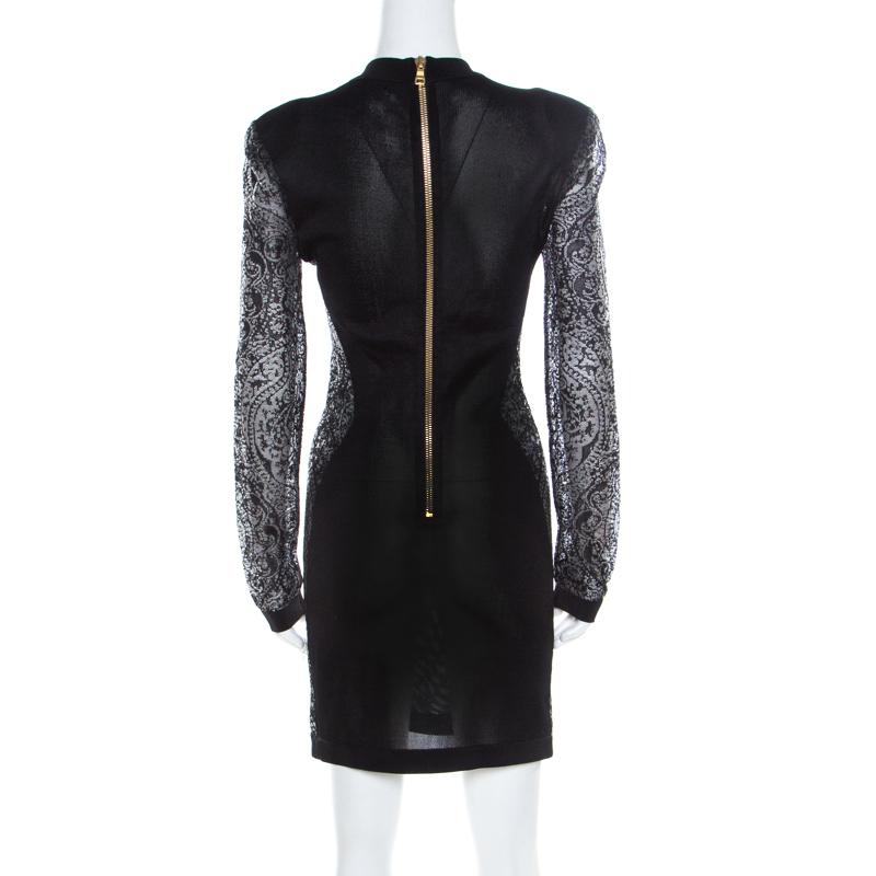 This creation from Balmain is so perfect it will not only give you a fabulous fit but will also lift your spirits because wearing good clothes can give one a pleasant feeling. Designed with sheer lace panels, this black bodycon dress can be worn