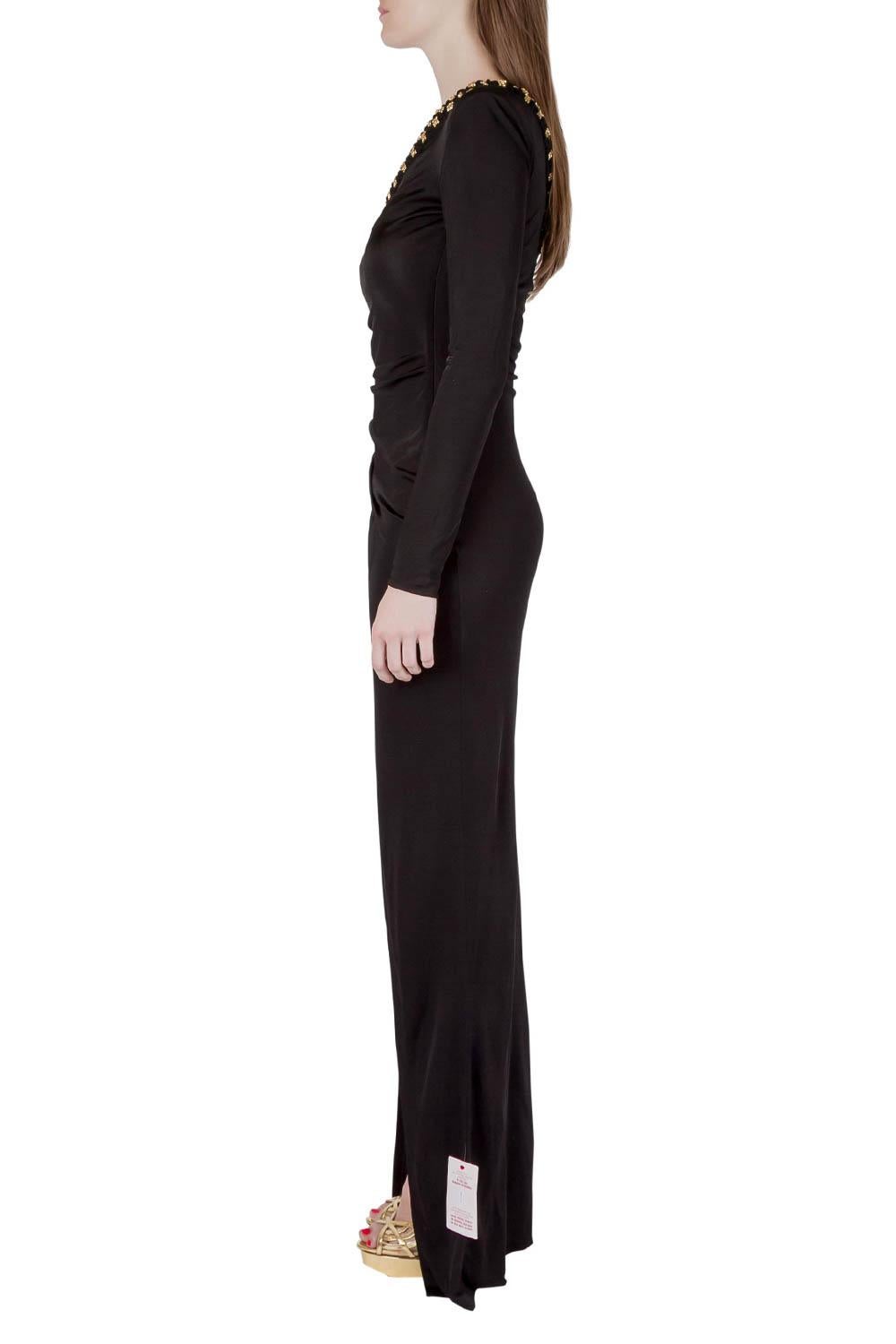 You are sure to feel glamorous in this gown by Balmain. The stretch knit gown brings a one-shoulder style with a long sleeve and crystal embellishments. It is also draped in such a way that a wide slit is formed on the front, thus allowing your