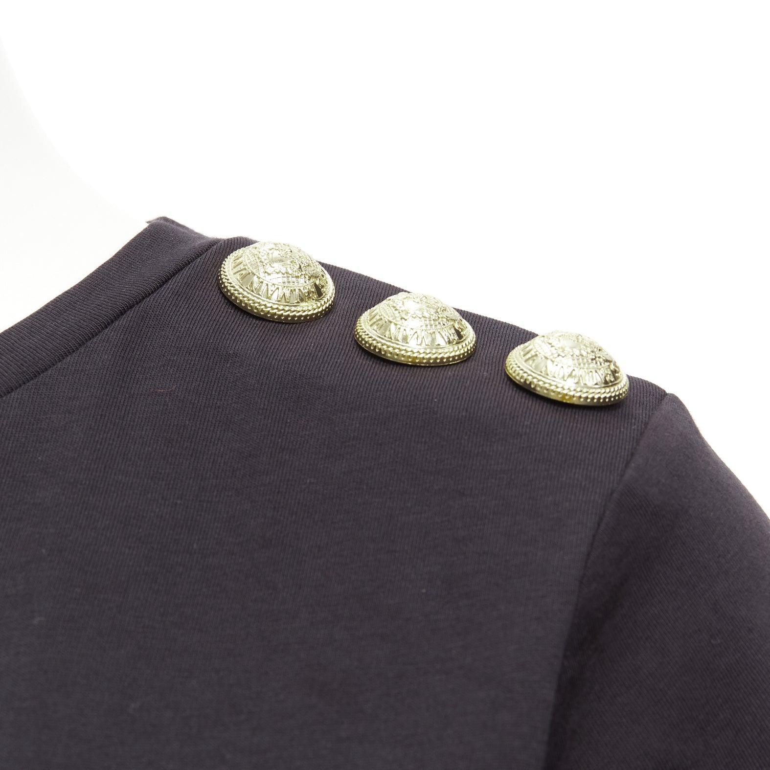 BALMAIN black white B logo gold military buttons tshirt FR34 XXS
Reference: AAWC/A00766
Brand: Balmain
Designer: Olivier Rousteing
Material: Cotton
Color: Black, White
Pattern: Solid
Closure: Slip On
Extra Details: Buttons are decorative.
Made in: