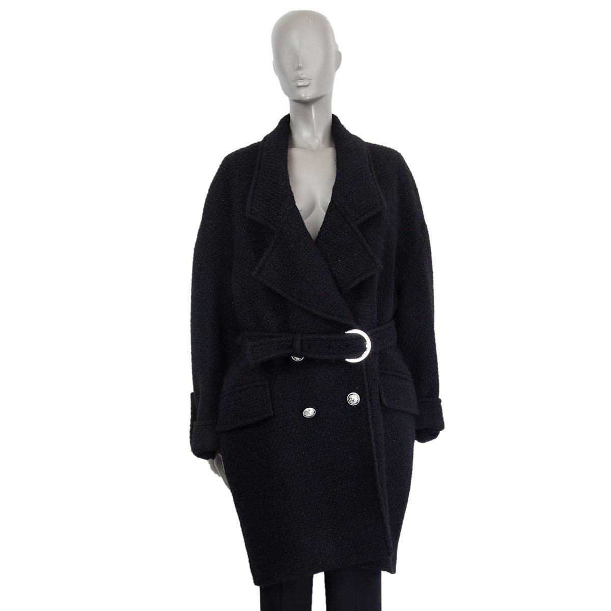 Balmain oversized belted double-breasted coat in black wool (96%) and polyamide (4%) with two flat pockets and folded buttoned cuffs. Lined in black cupro (100%). Closes with silver tone metal logo embossed buttons. Has been worn and is in excellent