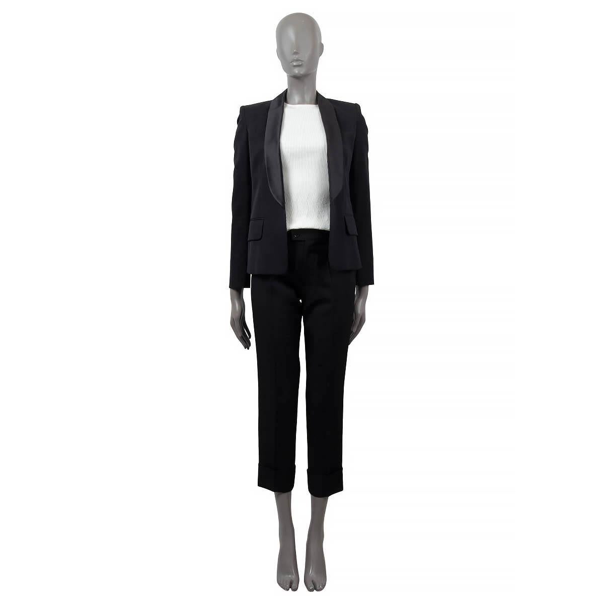 100% authentic Balmain open blazer in black wool (100%). Features a satin lapel and two flap pockets (one sewn shut) on the front. Lined in black viscose (52%) and cotton (48%). Has been worn with some light wear along the neck. Overall in excellent