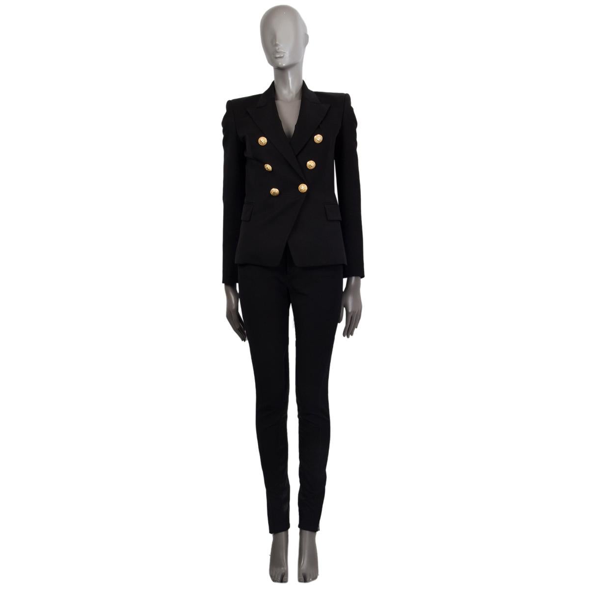 Balmain signature double-breasted blazer in black wool (100%) with gold-tone lion head buttons. Two flap pockets and a chest pocket on the front. Lined in viscose (52%) and cotton (48%). Has been worn and is in excellent condition.

Tag Size 36
Size