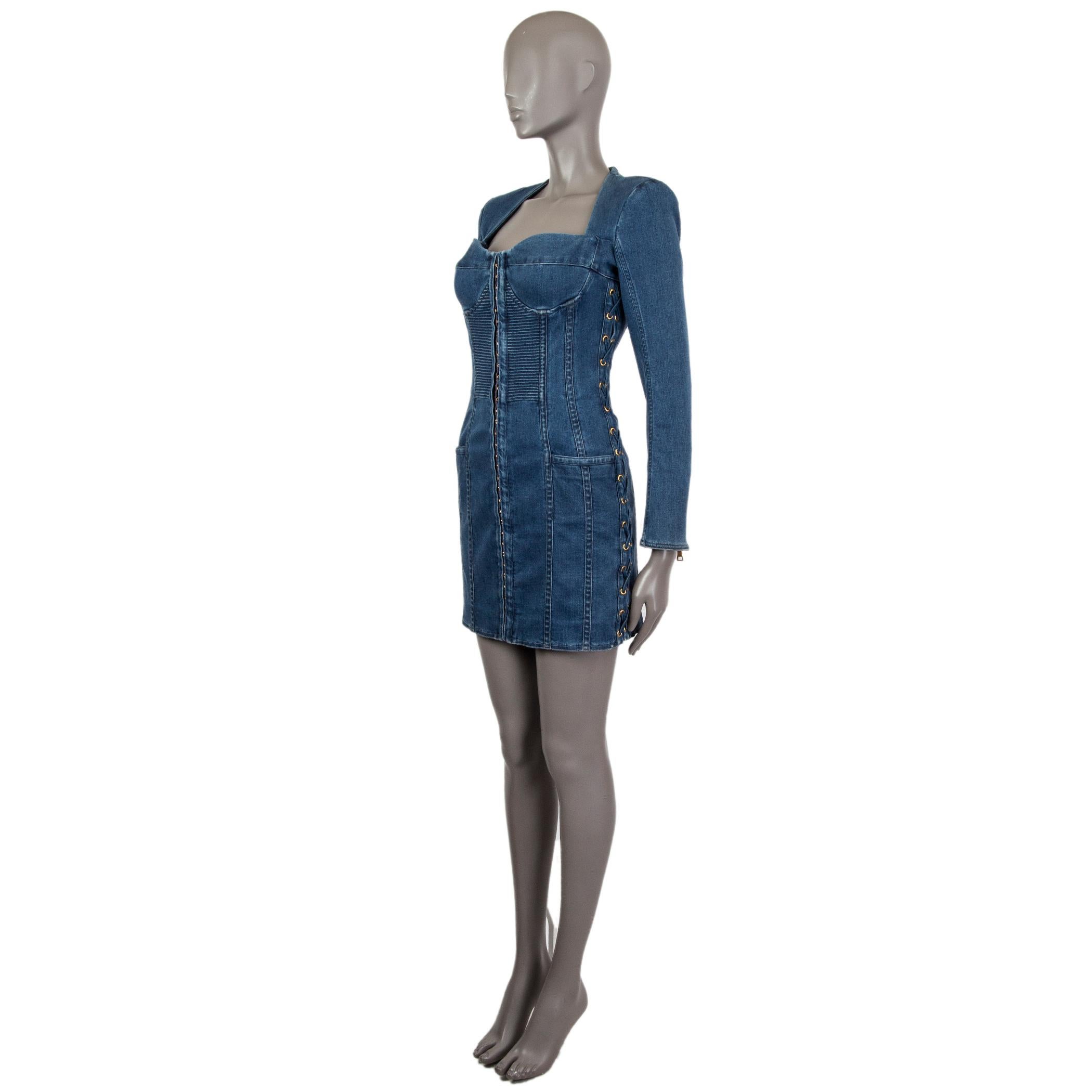 Balmain long-sleeved mini dress in indigo wash cotton (96%) elastane (4%) with zipped cuffs, lace-up panel at the sides and slit pockets at the hips. Featuring a bustier with a front panel hook and eye fastening, seam details, gold-tone hardware.