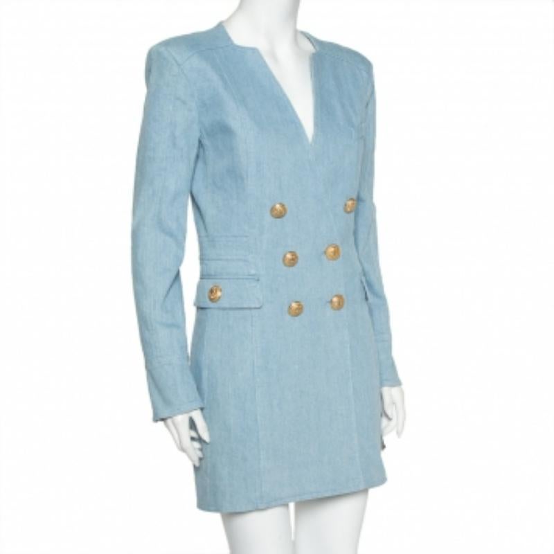 A blue denim dress by Balmain that you can effortlessly match with statement sandals, pumps, or boots. The mini dress brings a double-breasted front with gold-tone button details, a V neckline, three pockets, and a back zip closure.