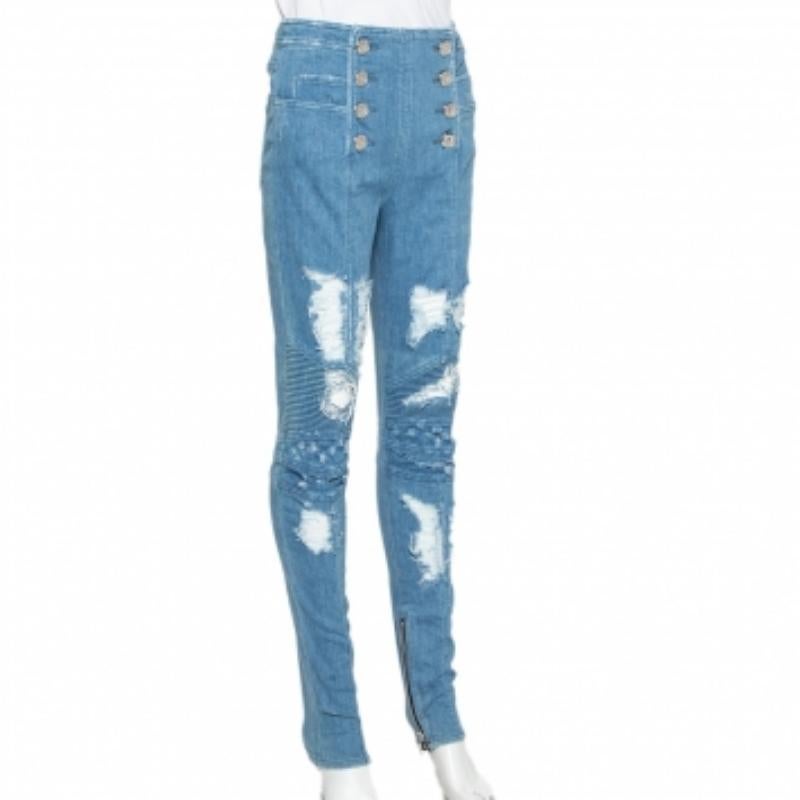 Balmain lends a fashionable twist to a simple pair of blue trousers with this creation. Made from a cotton blend, the jeans feature button detailing at the front, six pockets, distressed accents, and sewn-in zippers at the hem.