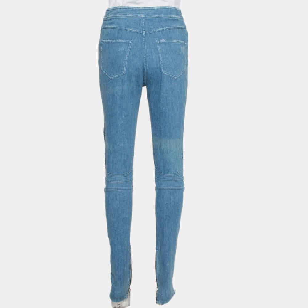 Balmain lends a fashionable twist to a simple pair of blue trousers with this creation. Made from a cotton blend, the jeans feature button detailing at the front, six pockets, distressed accents, and sewn-in zippers at the hem.

