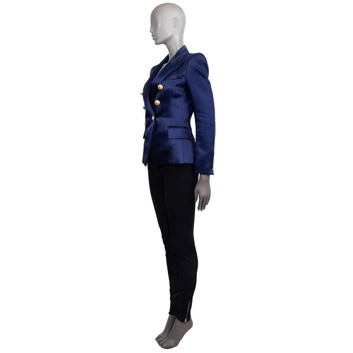 Balmain signature double-breasted satin blazer in navy acetate (52%) cotton (48%) with a slim-fitting silhouette, one patch pocket on the chest, two flap pockets and buttoned cuffs at the back. Closes with embosses gold-tone buttons in the front.