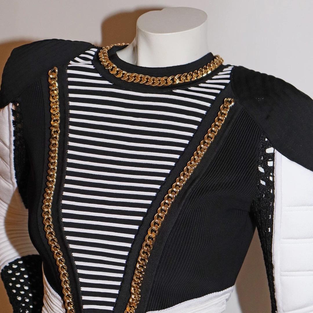 Balmain by Olivier Rousteing Bodysuit 
Spring / Summer 2018
Look 13 
Made in Italy 
Black and White 
Ribbed knit detailing 
Shoulders and sleeves have padded details with stitching 
Open crochet knit at cuffs of sleeves and on back of the bodysuit