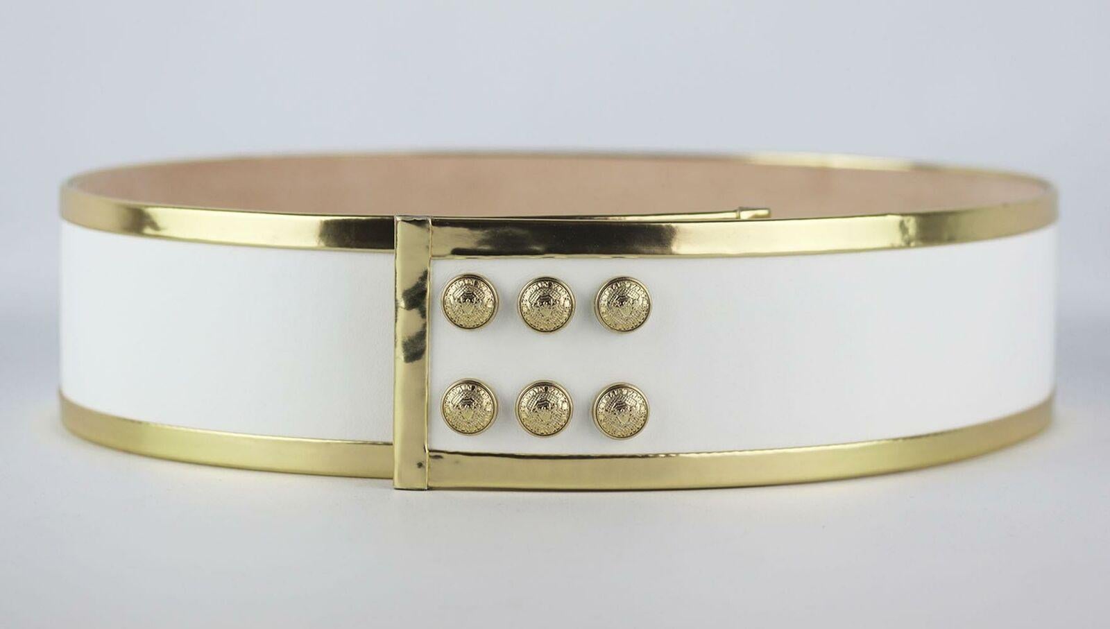 We can always count on Balmain for a glamorous finishing touch - this waist belt is made from soft white and gold leather, it has snap fastening and you'll notice they're the same the lion-embossed buttons that adorn the brand's iconic