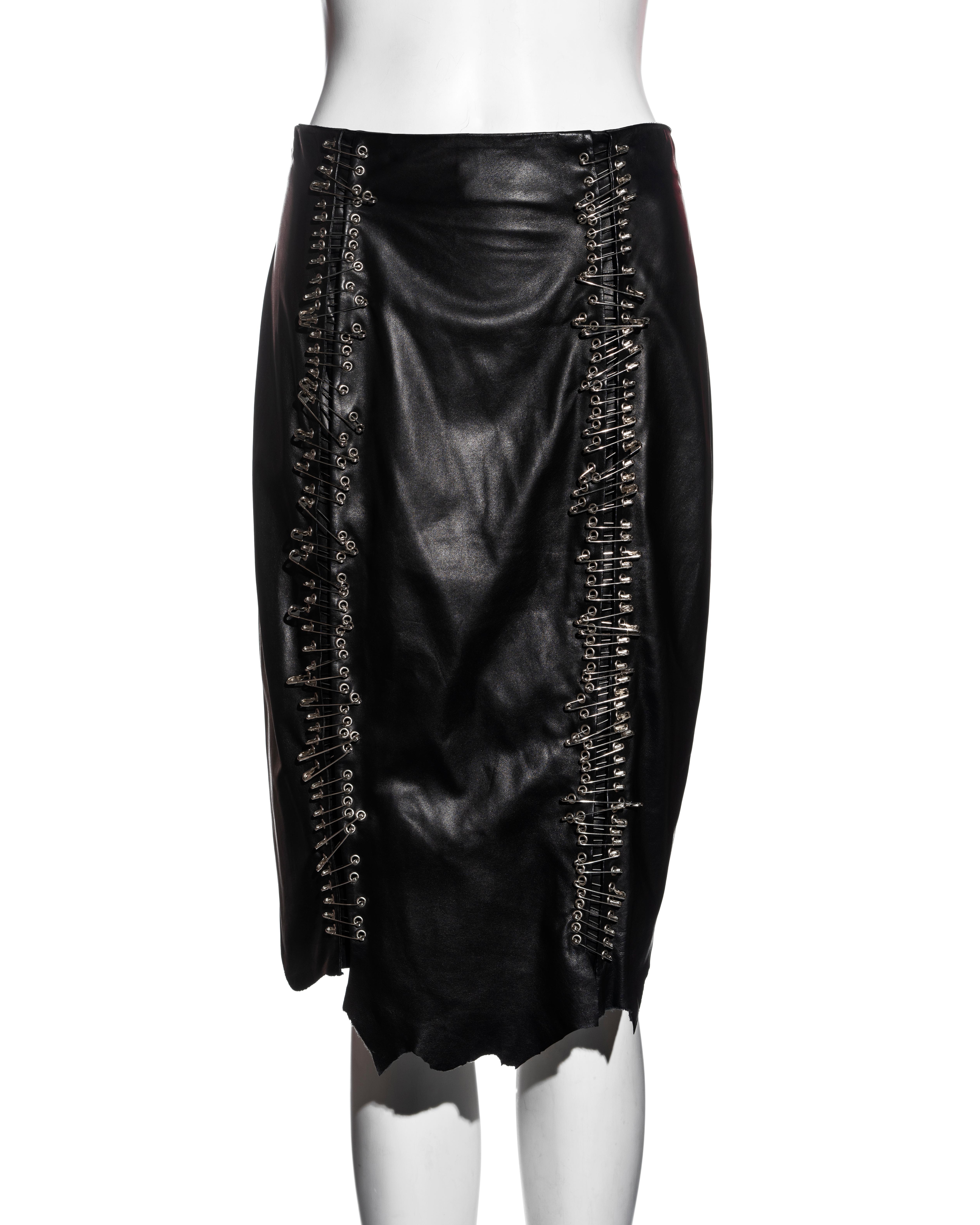 ▪ Balmain black leather safety-pin knee-length skirt 
▪ Designed by Christophe Decarnin  
▪ 2 rows of safety-pins at the front openings
▪ Raw-edge hemline  
▪ Silver metal zipper at centre-back  
▪ FR 40 - UK 12- US 8 
▪ Spring-Sumer 2011