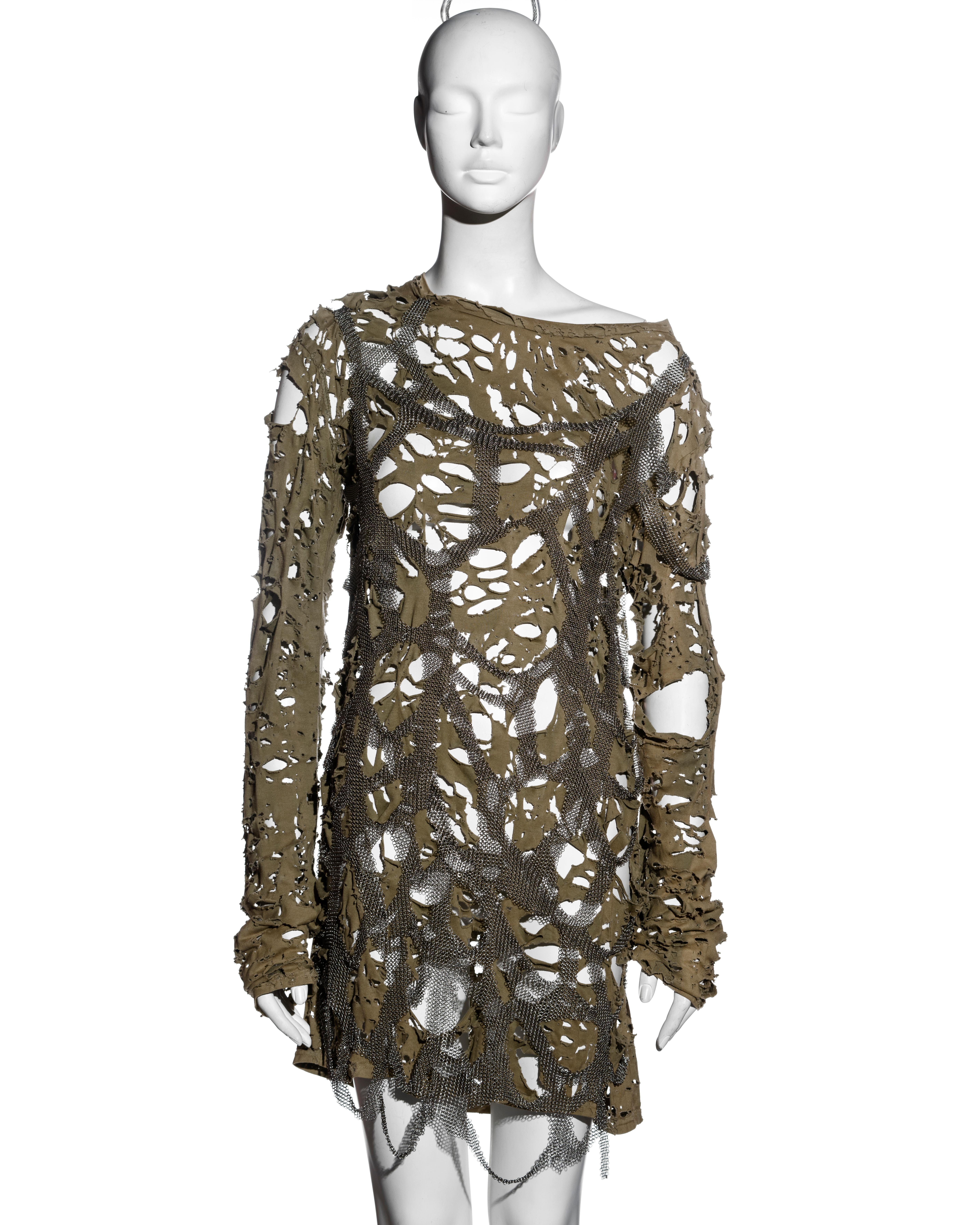 ▪ Balmain destroyed khaki green jersey mini dress
▪ Designed by Christophe Decarnin
▪ Rippings and holes allover the fabric
▪ Destroyed metal chainmail applied on top
▪ Wide neck 
▪ FR 38 - UK 10 - US 6
▪ Spring-Summer 2010
