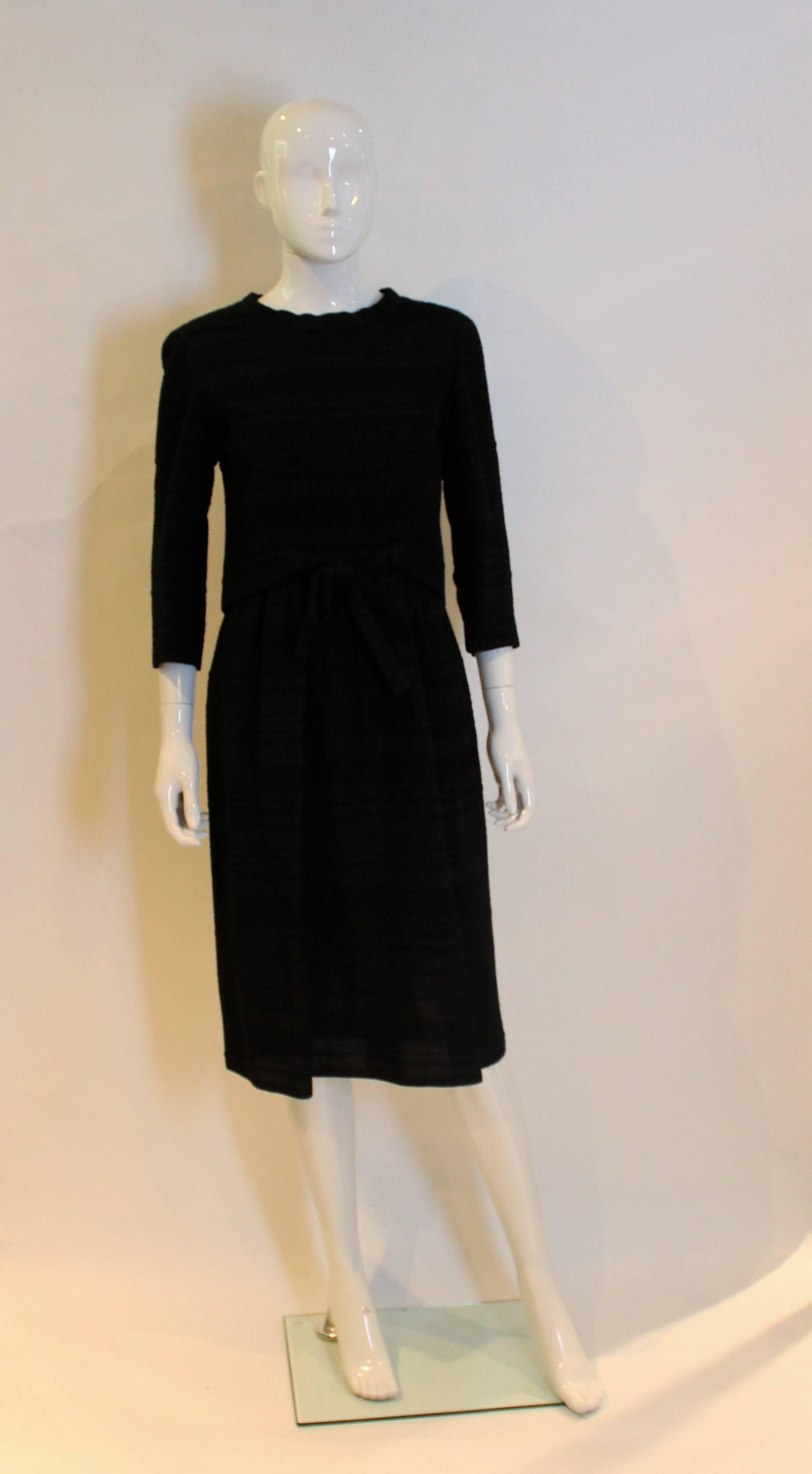 A chic dinner dress by Balmain. In a seersucker like fabric with silk lining. This dress is beautifuly  made with an outer zip to waist leval and internal zip for the lining. It has a 5 button back and elbow length sleeves.