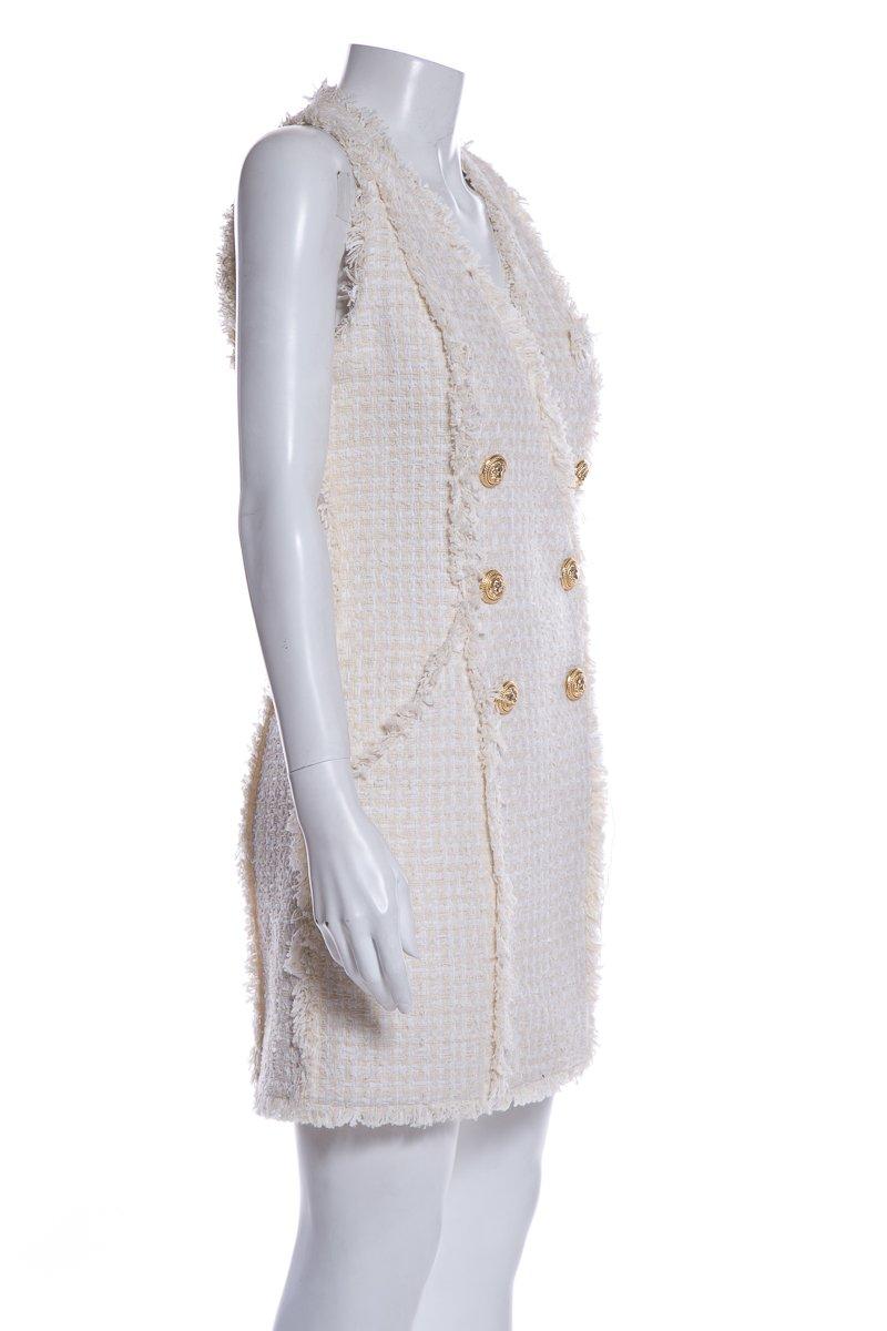 Balmain cream sleeveless tweed mini dress with fringed accents throughout, two pockets and button closures at front.
