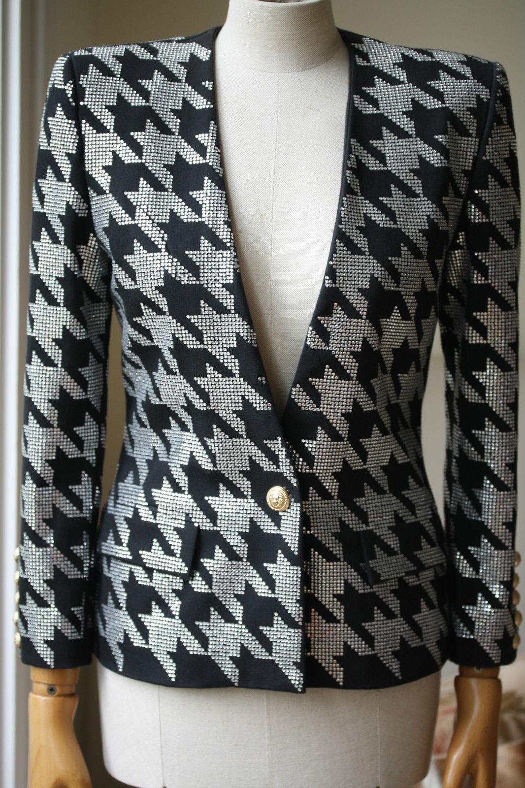 Black cotton blend embellished houndstooth jacket from Balmain featuring a v-neck, a gold-tone front button fastening, front flap pockets, three-quarter length sleeves and button cuffs.

Size: FR 38 (UK 10, US 6, IT 42)

Condition: No sign of wear. 