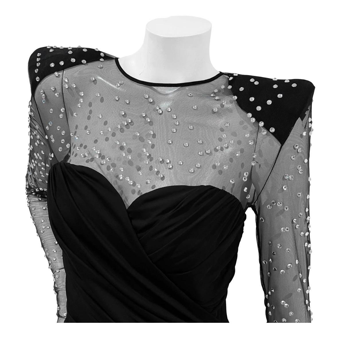 Long Sleeve Crystal Mesh Gown by Balmain
Made in France
Black
Mesh sleeves and top with decorative crystal embellishment
Black shoulder pad detail
Heart style neckline
Ruched and dual layer detail and on gown
Large bottom cut out detail
Back