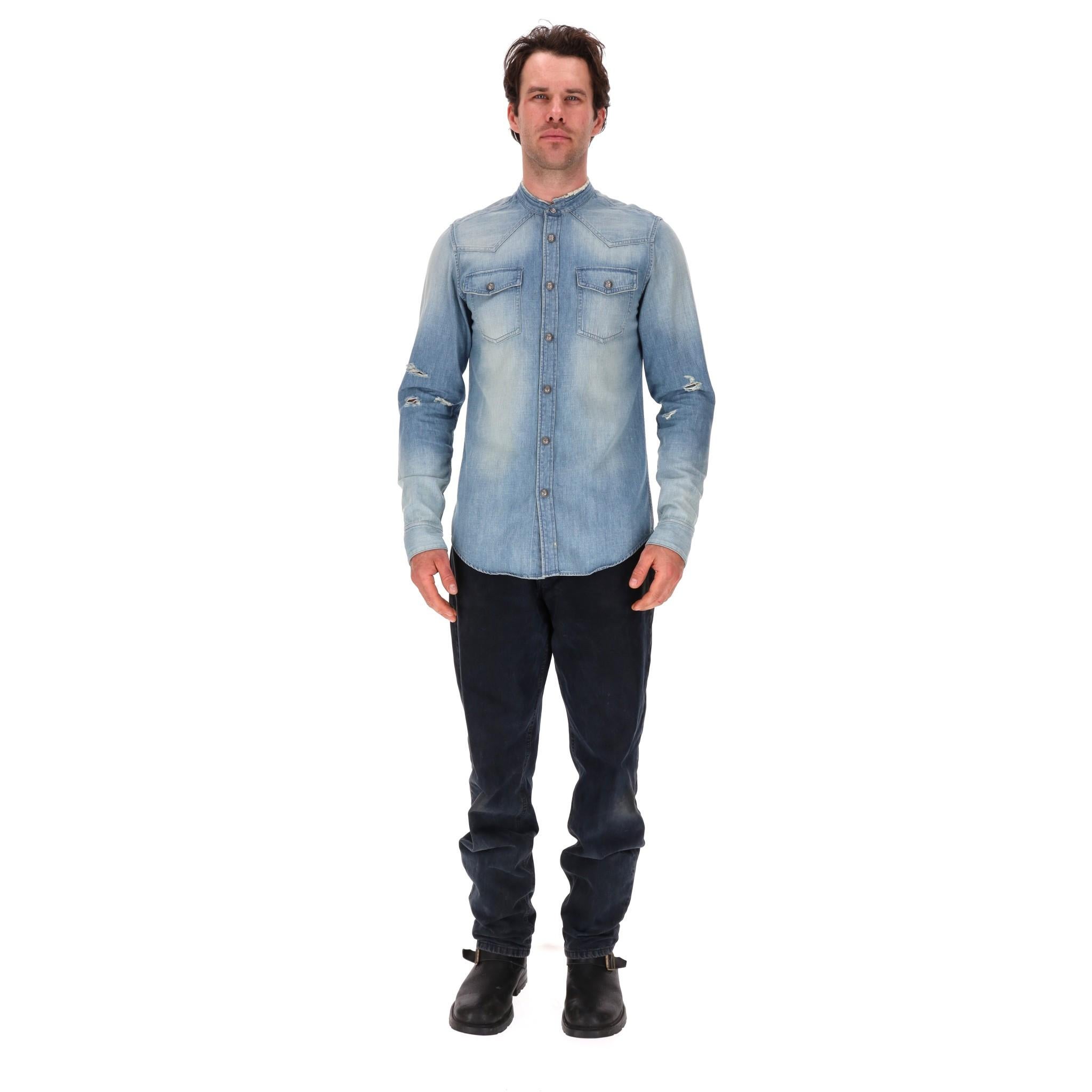 Balmain Faded Denim Shirt With Embroidered Logo Back

Silver embossed iconic button closure and cuffs with white embroidered logo to the rear, two button down patch pockets and grandad style collar.

Rrp £1,200

Size - 39 - M

Condition - Very