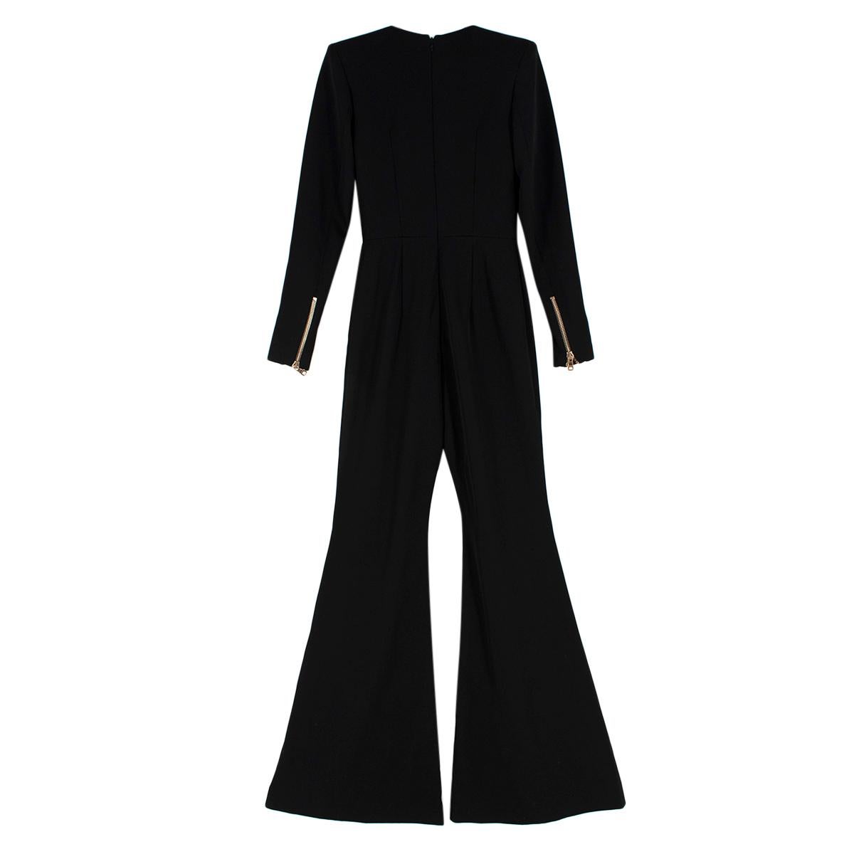 Balmain Double Breasted Wool Jumpsuit

- Handcrafted black wool jumpsuit
- V-shape neckline
- Exaggerated flared leg design
- Rows of signature Balmain gold buttons to make a bold statement
- Structured padded shoulders
- Zipped cuffs 

Made in