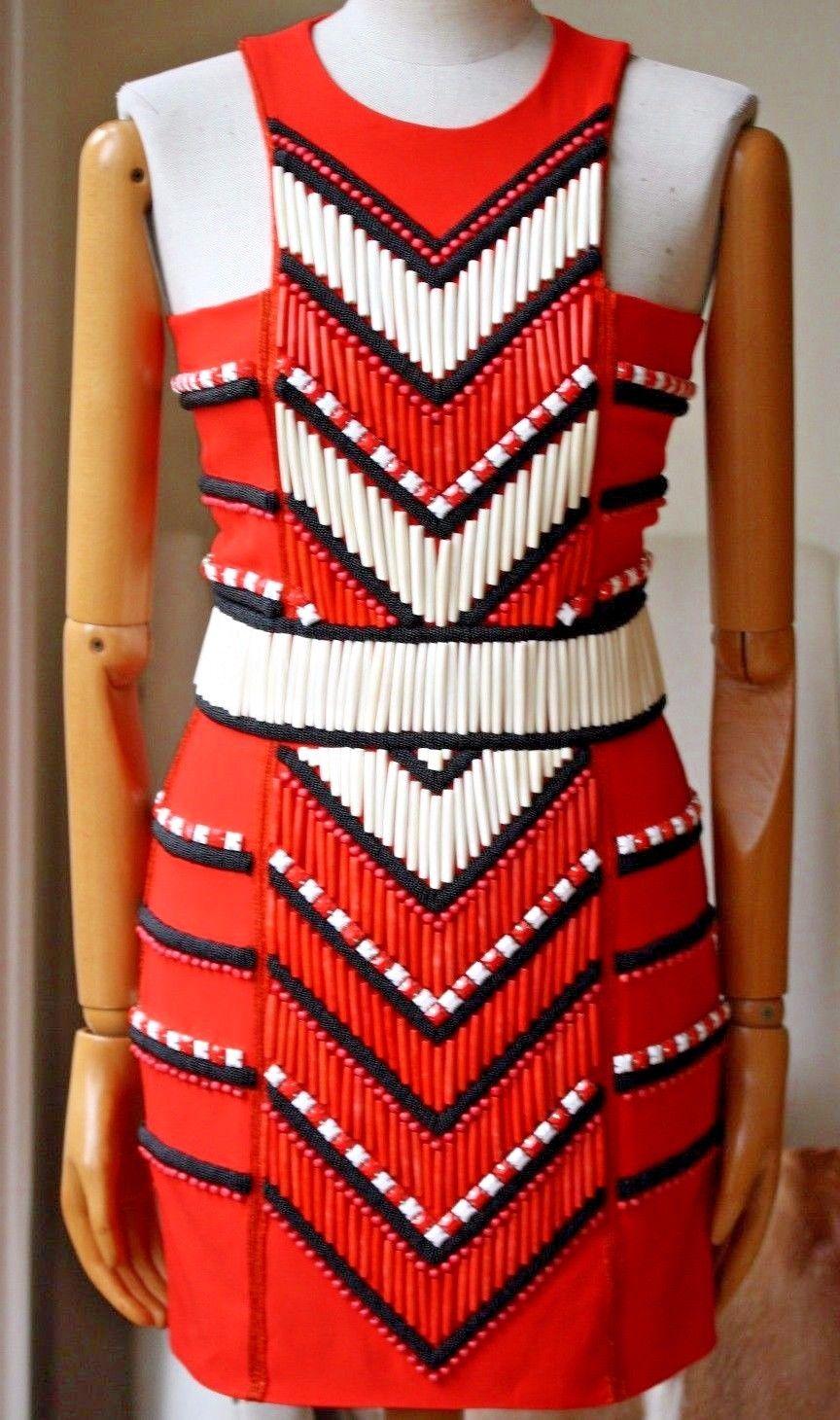 This thigh-skimming style is cut to sit close to the body and is embellished with beads and bone in a graphic pattern. Bright-red crepe. Zip fastening through back. 71% acetate, 29% viscose; embellishment: 50% camel bones, 45% buffalo bones, 5%