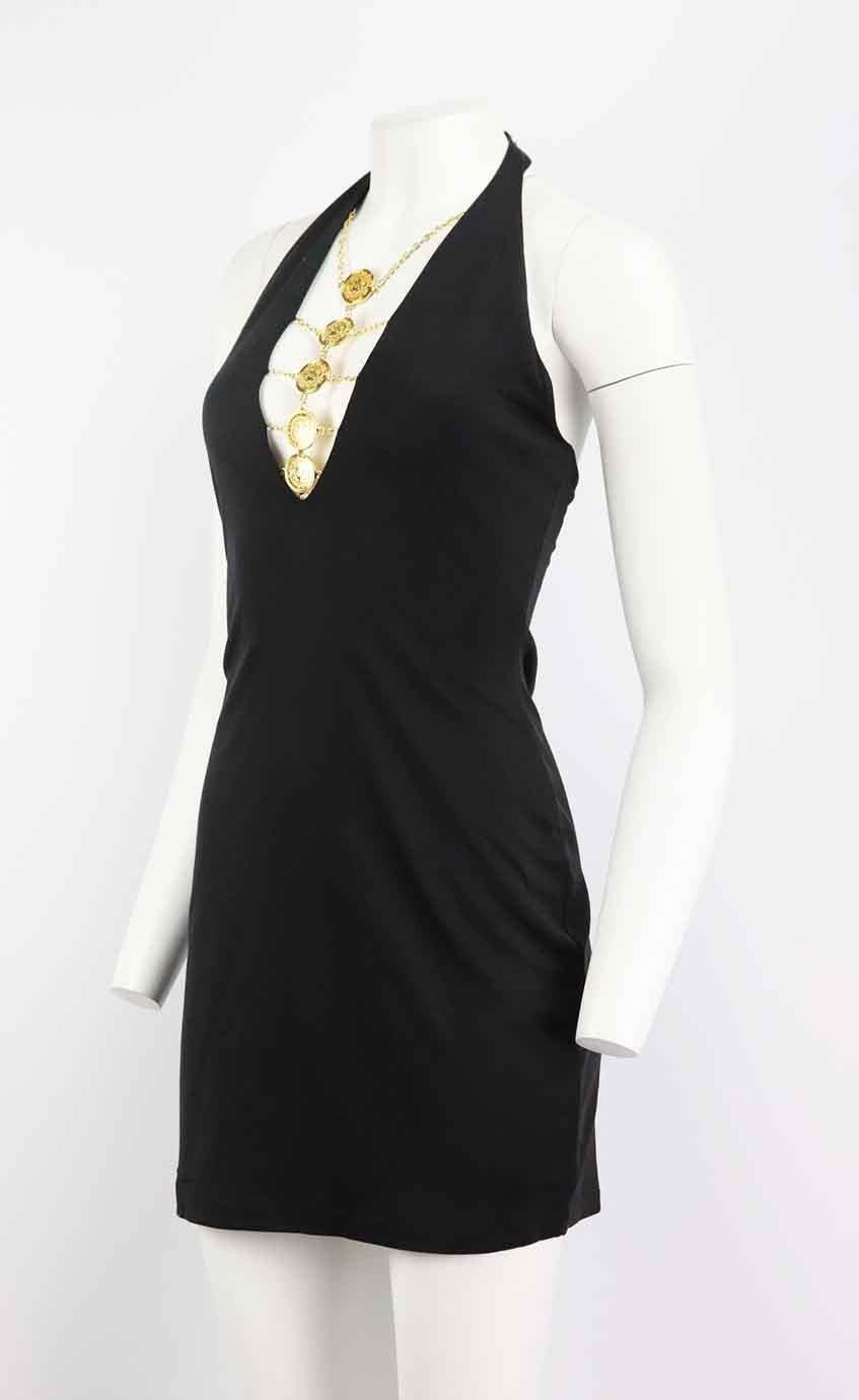 This mini dress by Balmain has an unmistakably 90’s feel, cut from stretch-knit in a bodycon shape, this style has slender halterneck straps that are accentuated with gold-tone medallion and chain detail on the front. Black viscose-blend. Snap