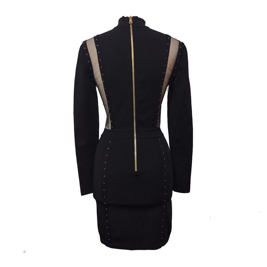 Viscose (91%) polyamide and elasthane Black color With transparencies Long sleeves Golden zip Maximum length cm 80 (314 inches) Shoulder cm 36 (141 inches) French size 36 italian 40        