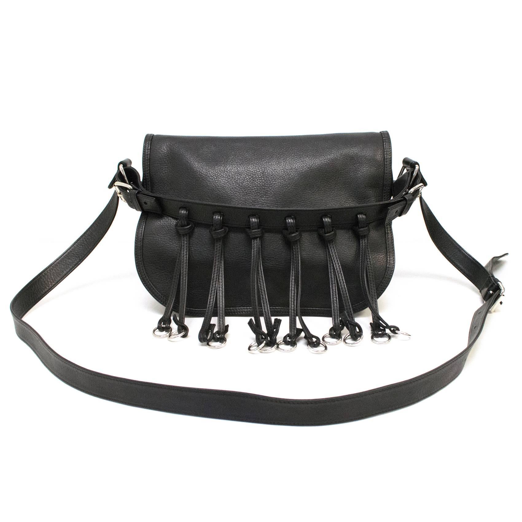 Balmain black leather saddle bag with shoulder strap and fringe. Features an inner compartment and adjustable straps. Fringe has silver rings to match silver hardware. Please kindly note fringe is missing one ring, (please refer to images 2 for