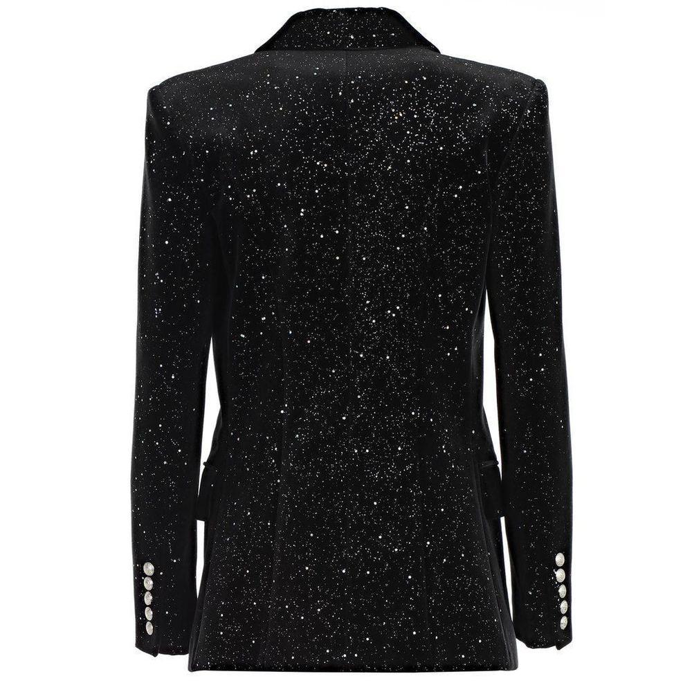 Balmain's black velvet blazer is given an opulent spin for the new season, featuring speckled silver star glitter across the slim-fitting body.
It's tailored in italy with padded shoulders and slender shawl lapels, then finished with antiqued