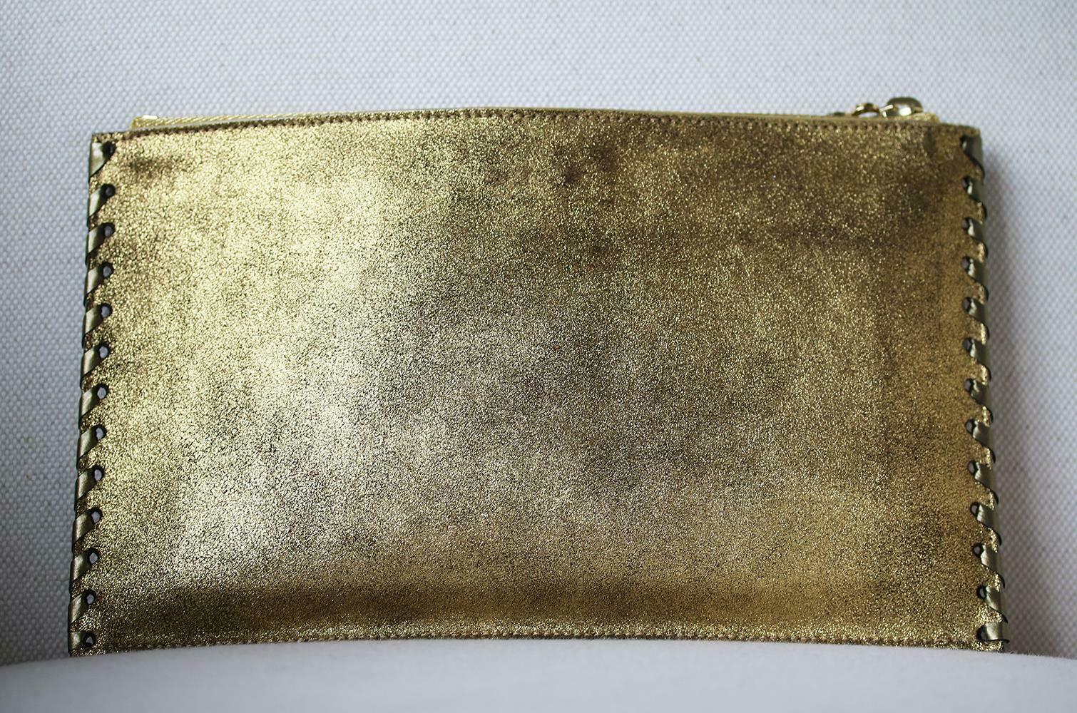 Balmain master of all things fabulously glamorous never fails to deliver. This crystal embellished soft suede pouch with top zipper fastening is the perfect summer accessory. Crafted from burnished gold soft suede and finished with a top layer of