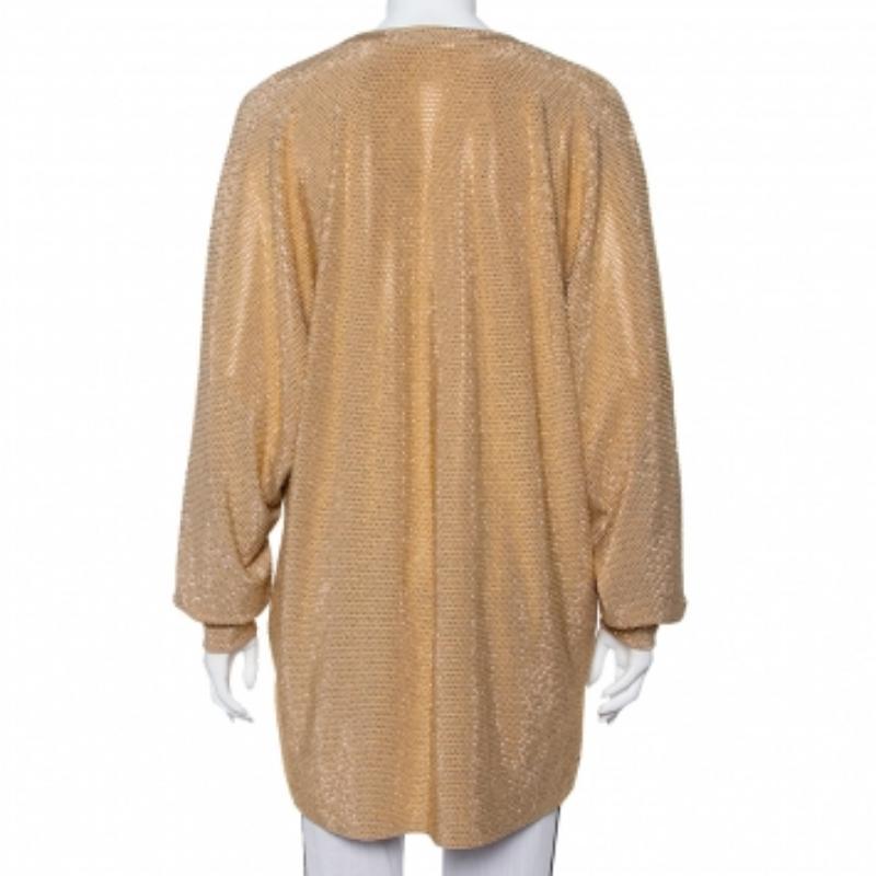 If you're looking for a statement top, we've got just the one you need! It is a Balmain design, grand in gold and eye-catching in appeal. The top is tailored into an oversized style and enhanced with long sleeves, a V neckline, and rhinestones