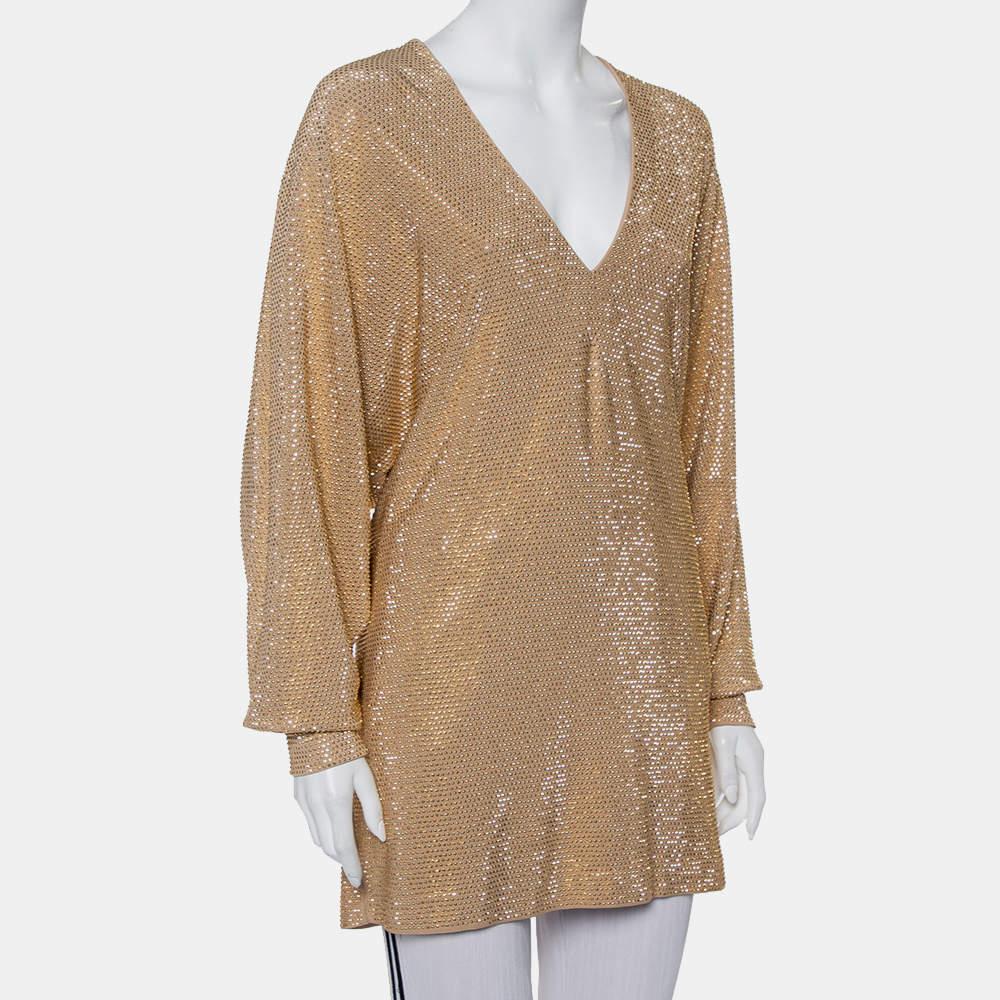 If you're looking for a statement top, we've got just the one you need! It is a Balmain design, grand in gold and eye-catching in appeal. The top is tailored into an oversized style and enhanced with long sleeves, a V neckline, and rhinestones
